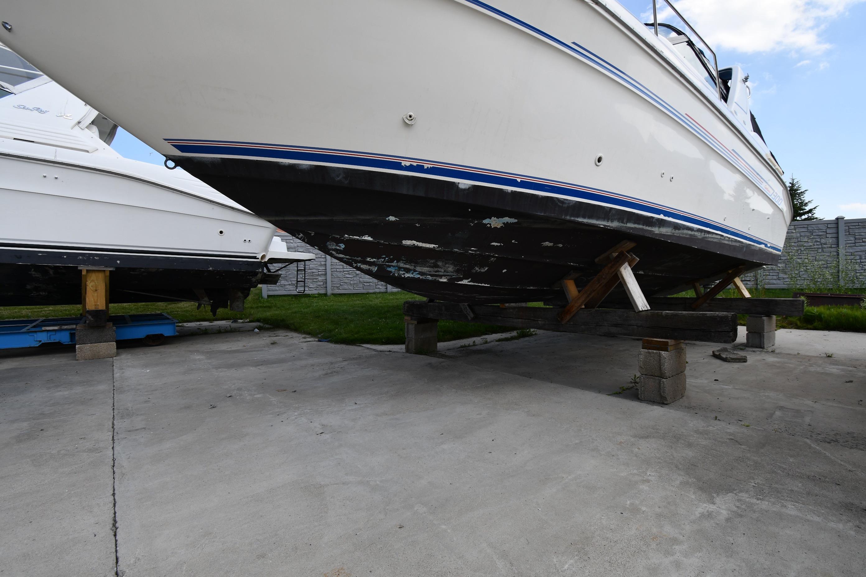 1993 Sea Ray 300 Sundancer boat on dry dock, showing hull and support structure.