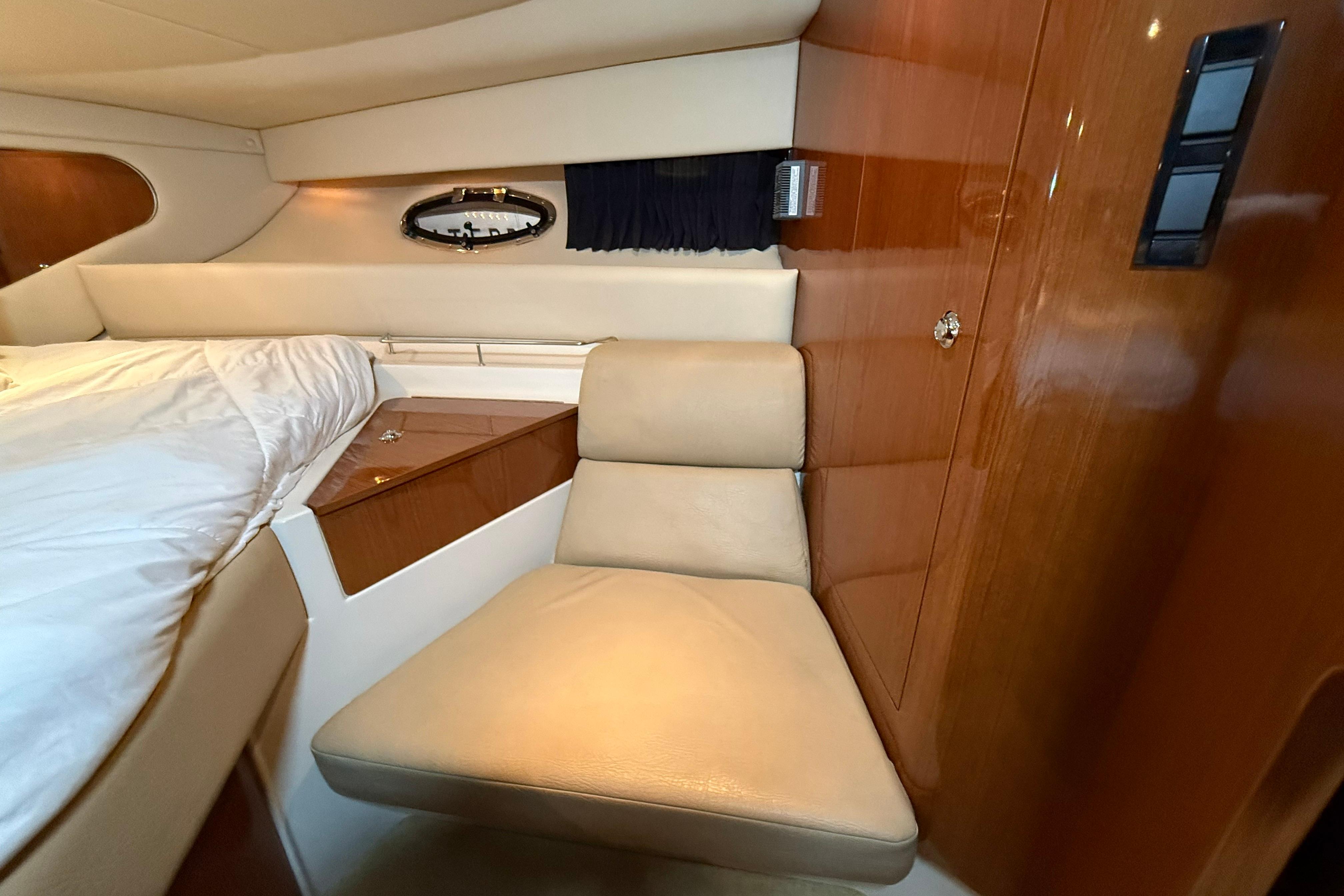 Interior of 2007 Regal Commodore 3760 IO yacht with beige seating and wood paneling.