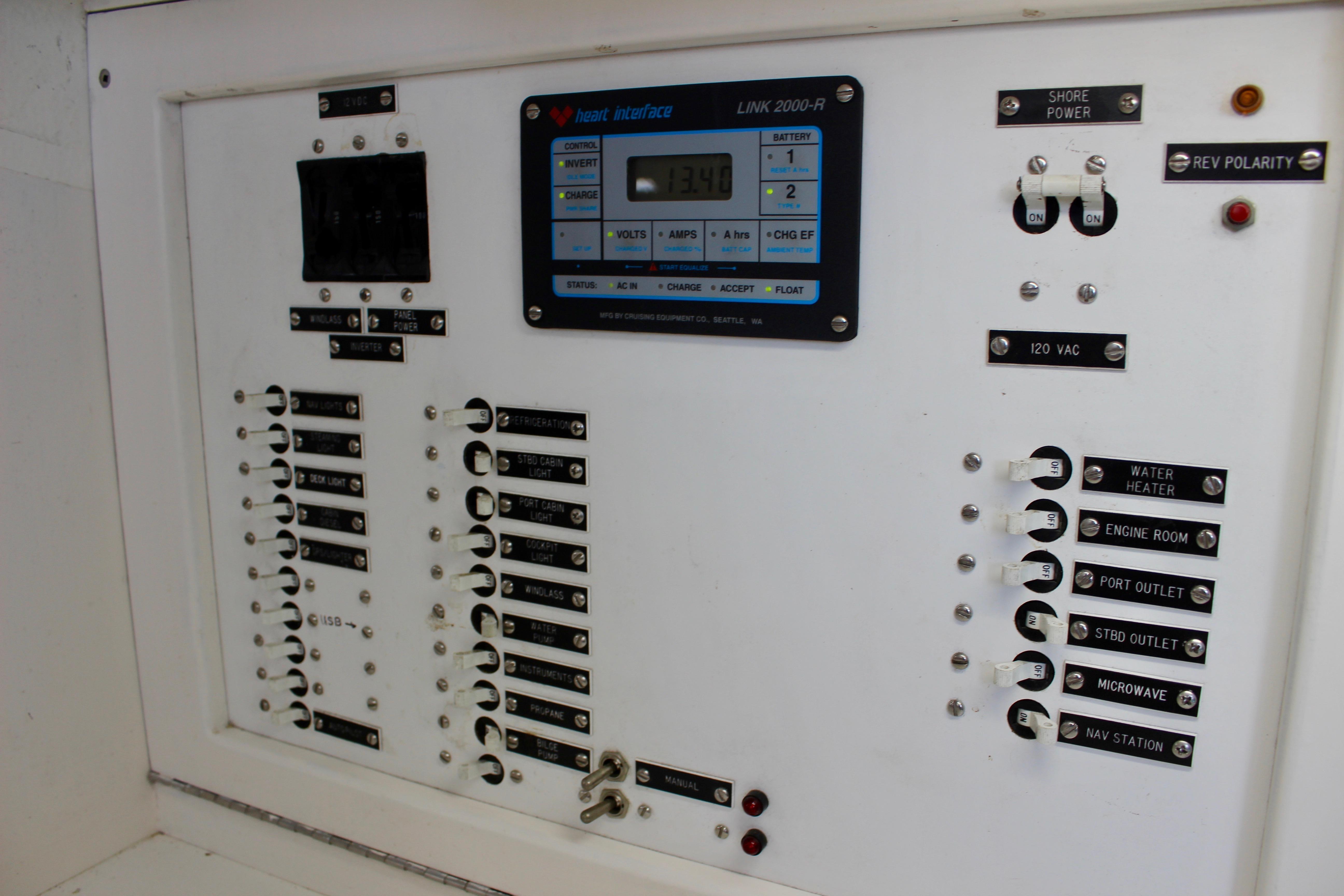 Electrical control panel on a 1993 Freya 39 boat, featuring switches and a digital display.