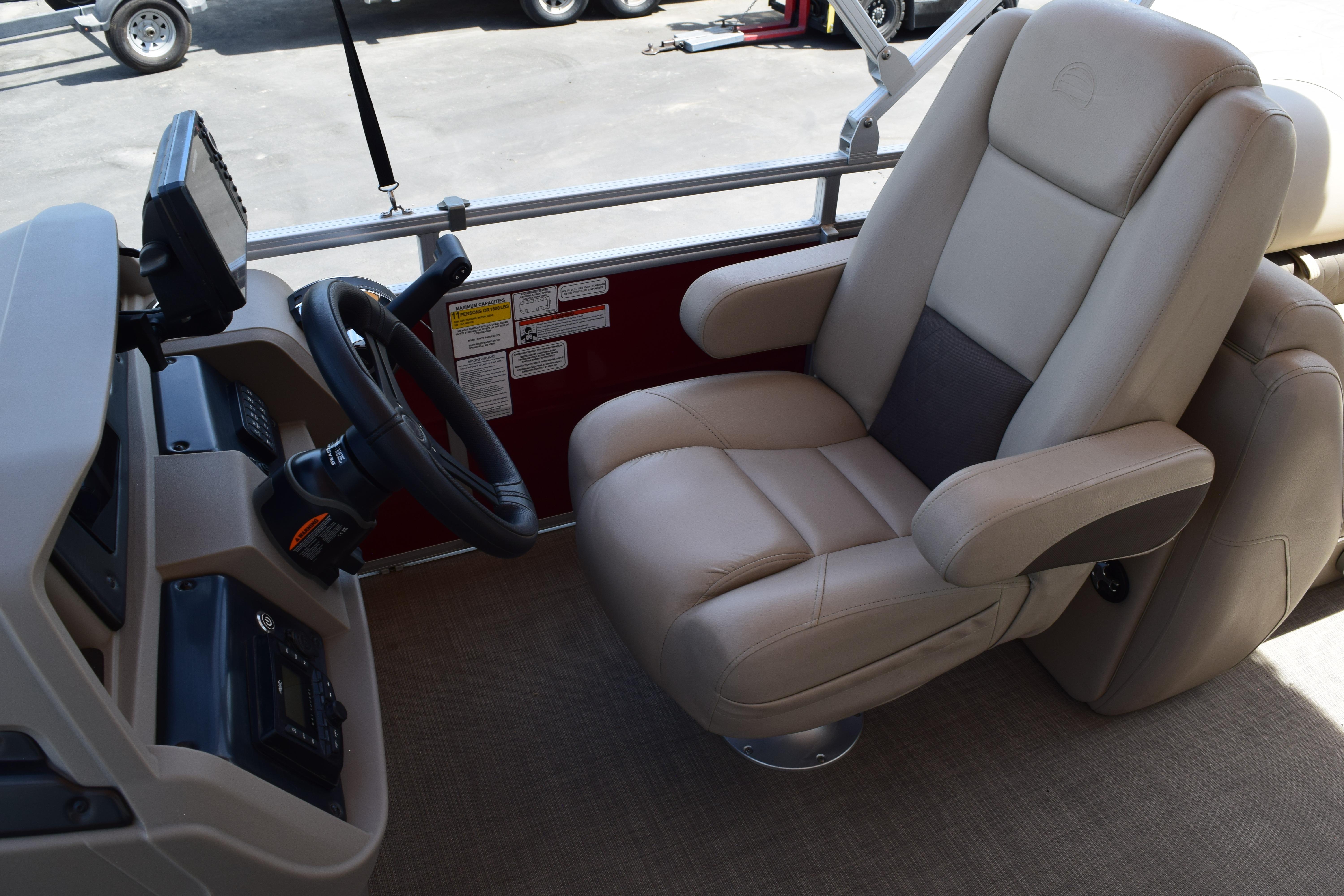 Captain's chair and helm of 2025 Sun Tracker Party Barge 22 XP3 pontoon boat.