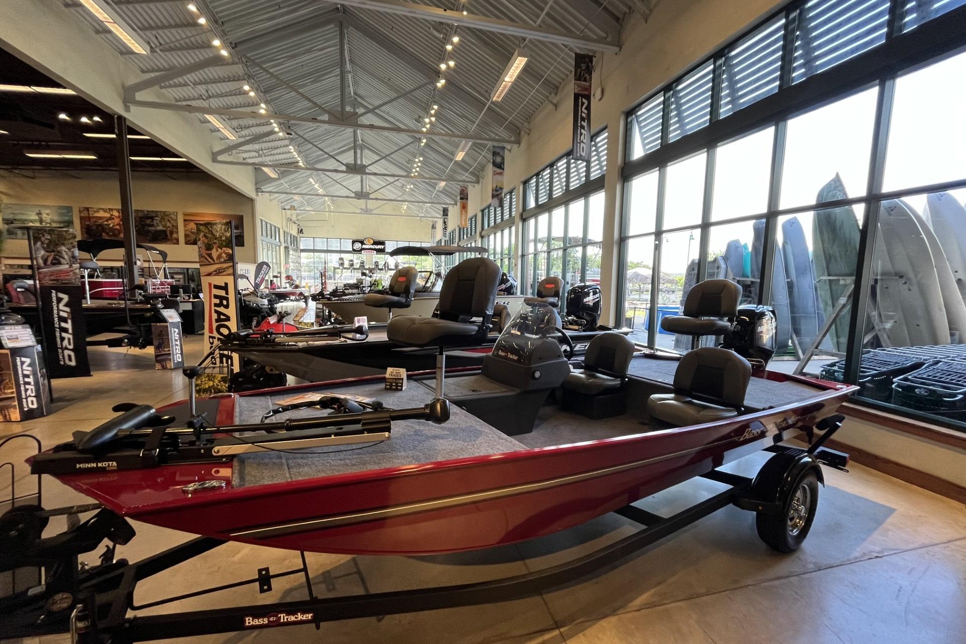 2026 Tracker Bass Tracker Classic XL boat displayed in a showroom with large windows.