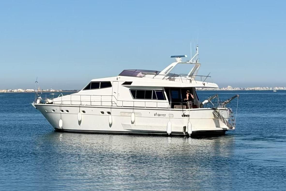 1990 Sanlorenzo 57 yacht on calm waters.