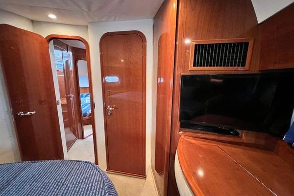 Interior of 2003 Viking Princess 50 Sport Cruiser with wood paneling and TV.