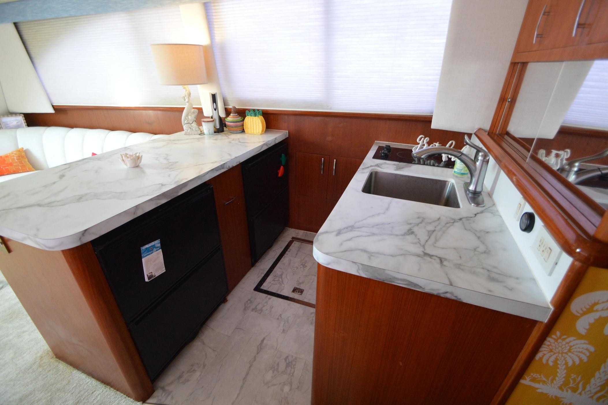 Luxurious 1995 Ocean 48 Cockpit Motor Yacht interior with marble countertops and modern amenities.