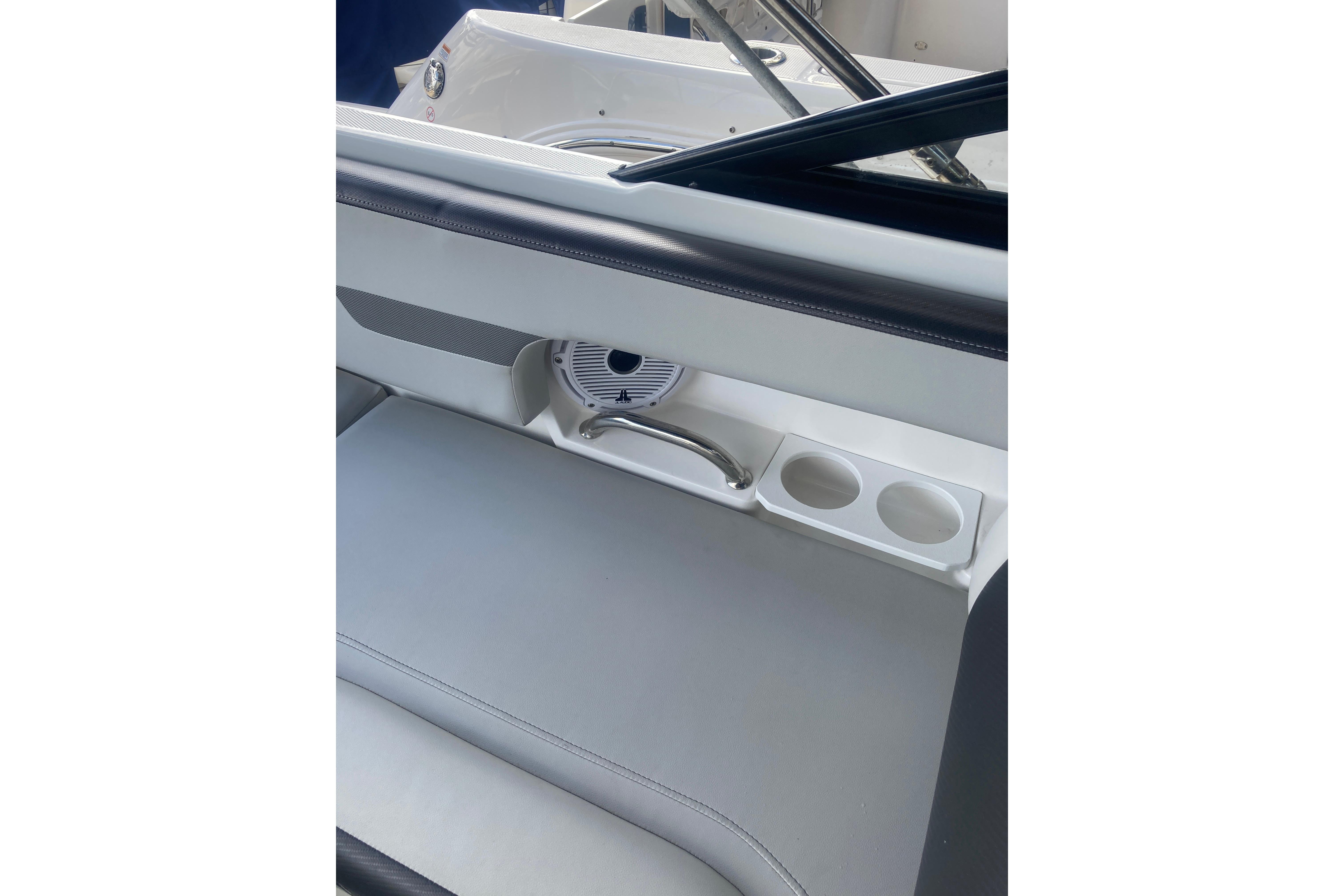 Interior of 2023 Hurricane SunDeck 235 OB boat with seating and cup holders.