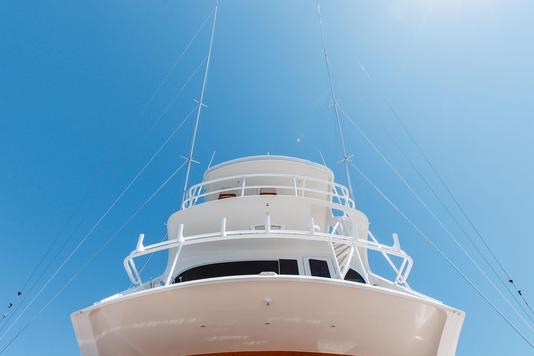2016 Viking 82 Sky Bridge yacht against clear blue sky.