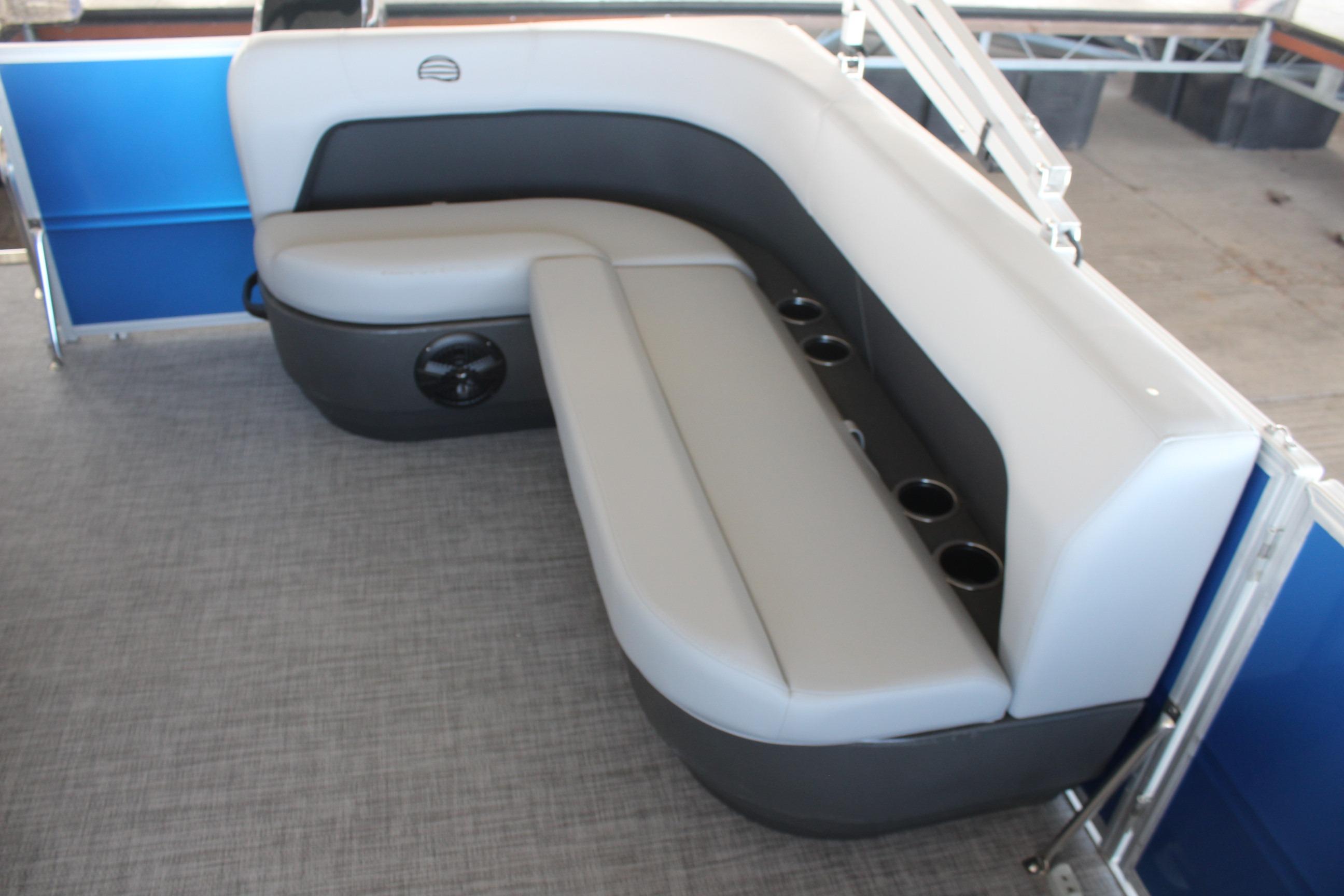 2026 Sun Tracker Party Barge 16 DLX interior seating with cup holders and gray upholstery.