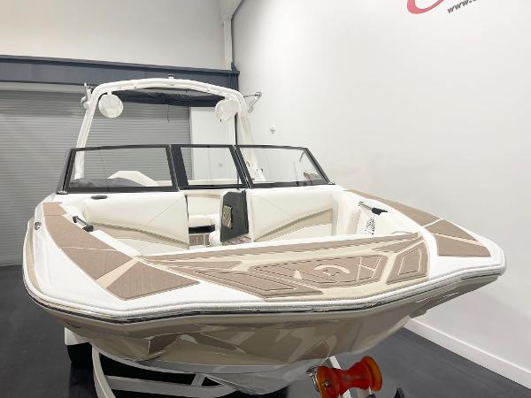 2025 Centurion NV213 boat in showroom, featuring sleek design and modern interior.