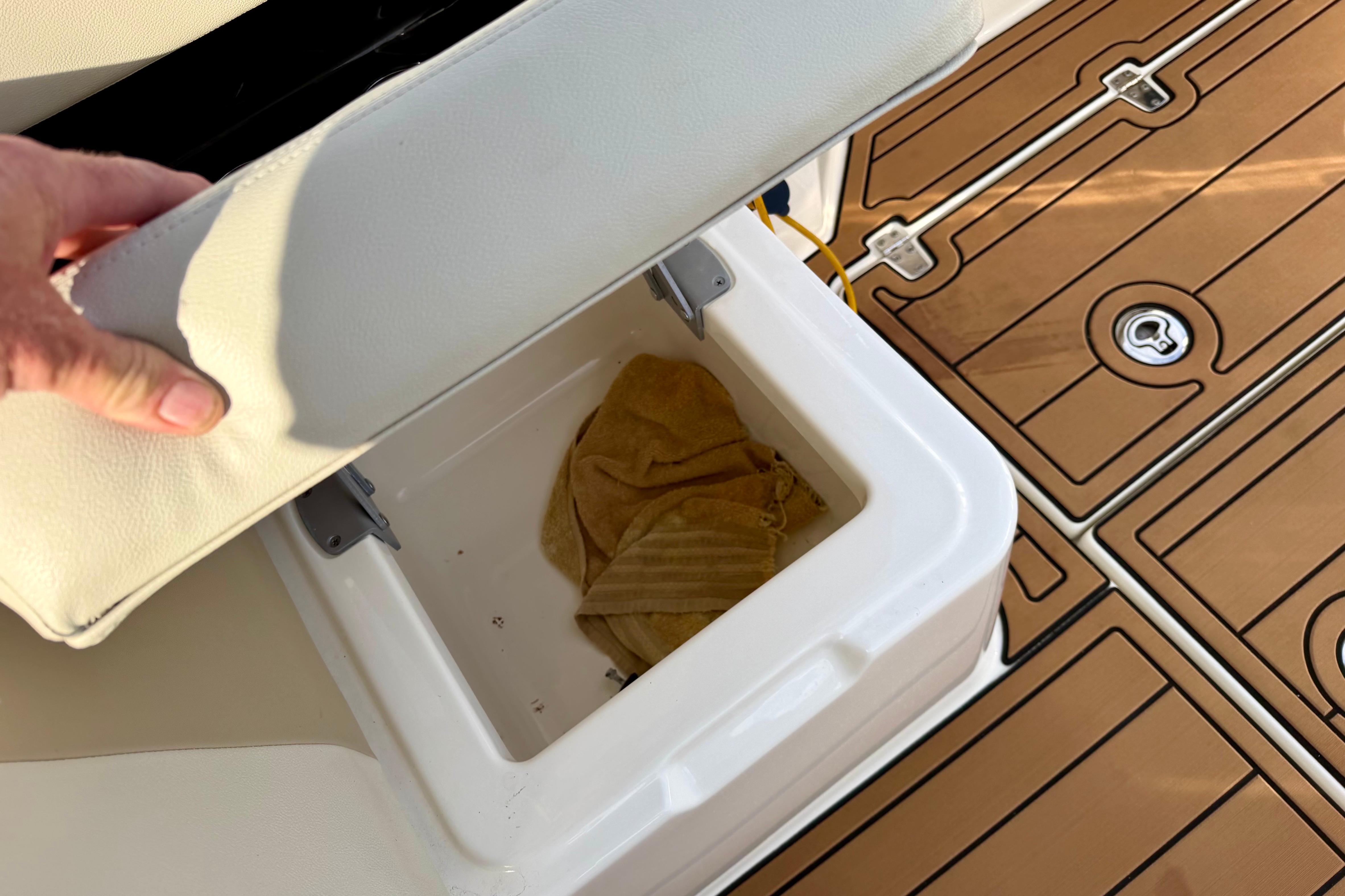 2022 Boston Whaler 280 Vantage seat storage compartment with teak-style flooring.