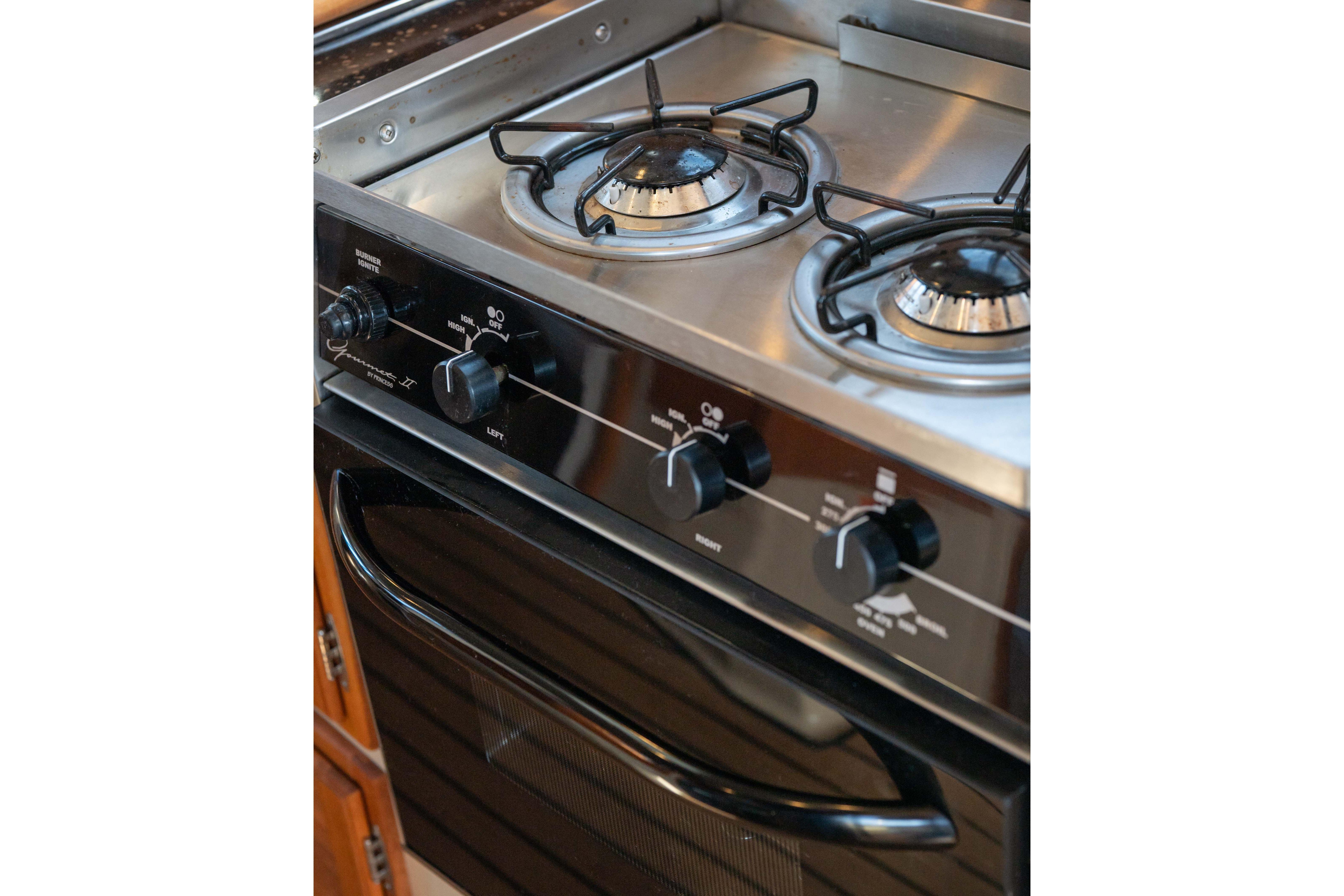 Stainless steel stove with two burners on a 2014 Ranger Tug R-31 CB boat.