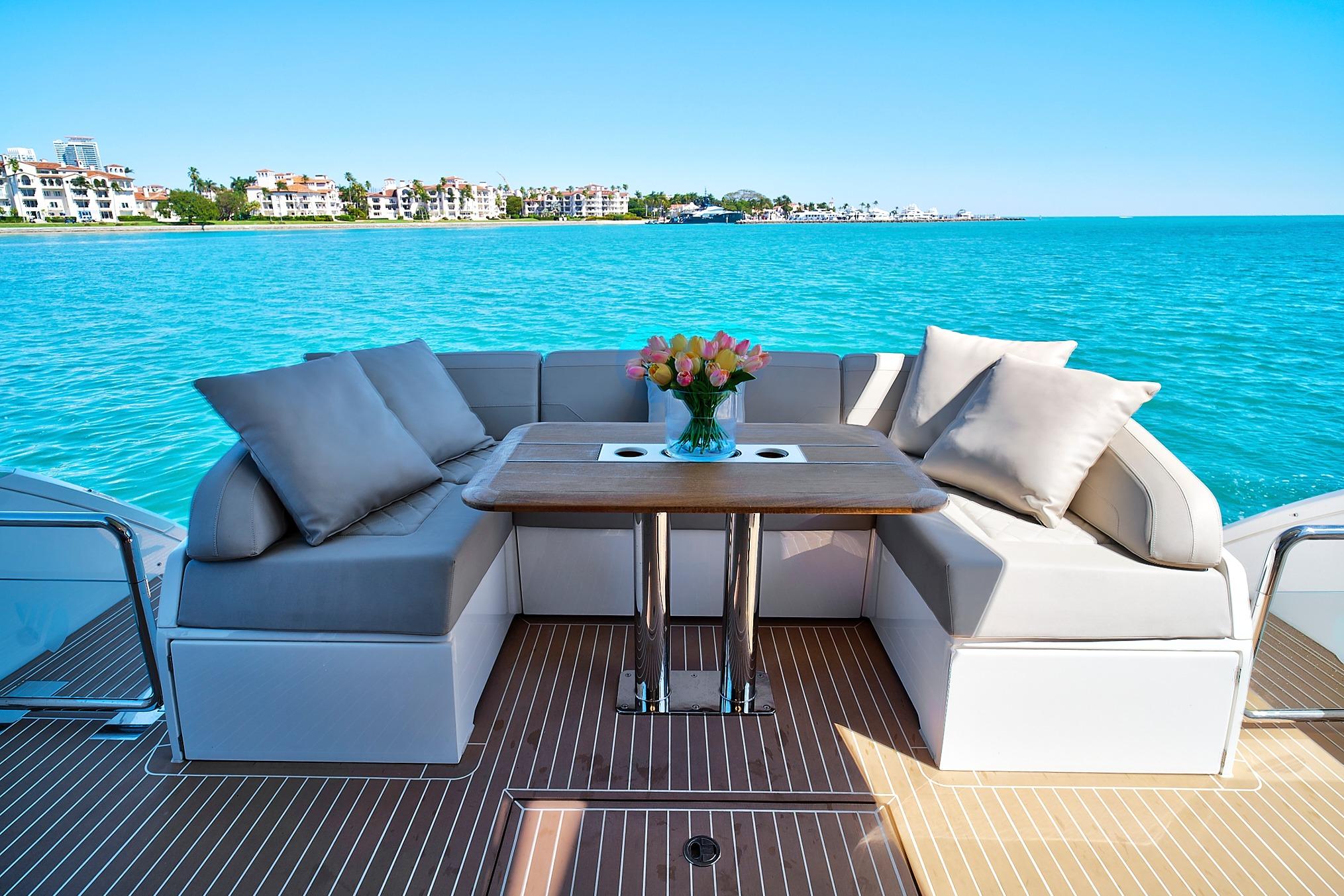 Luxurious 2021 Fairline Squadron 68 yacht deck with elegant seating and ocean view.