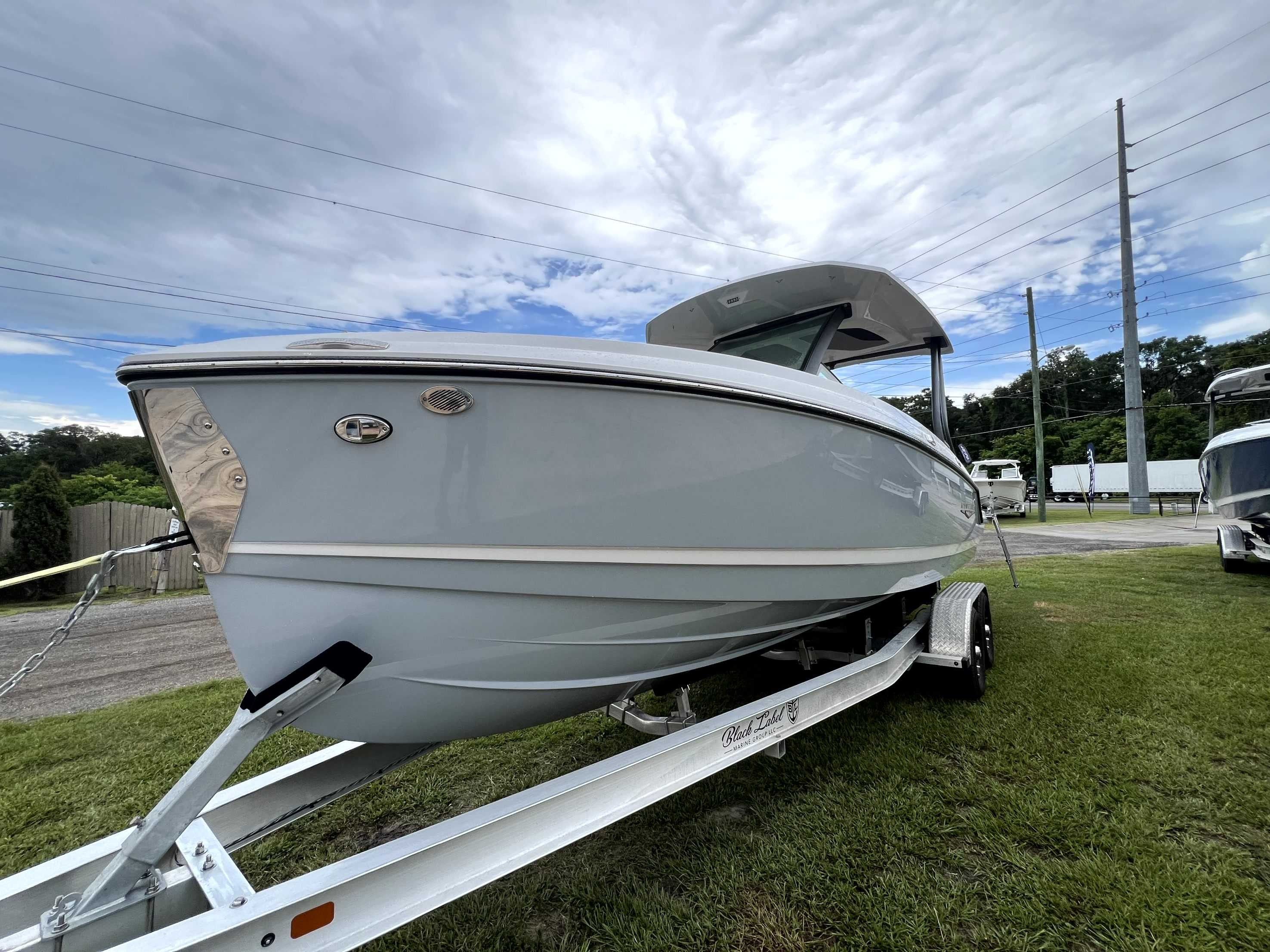 A 2026 Monterey Elite 25 boat on a trailer, positioned on grass.
