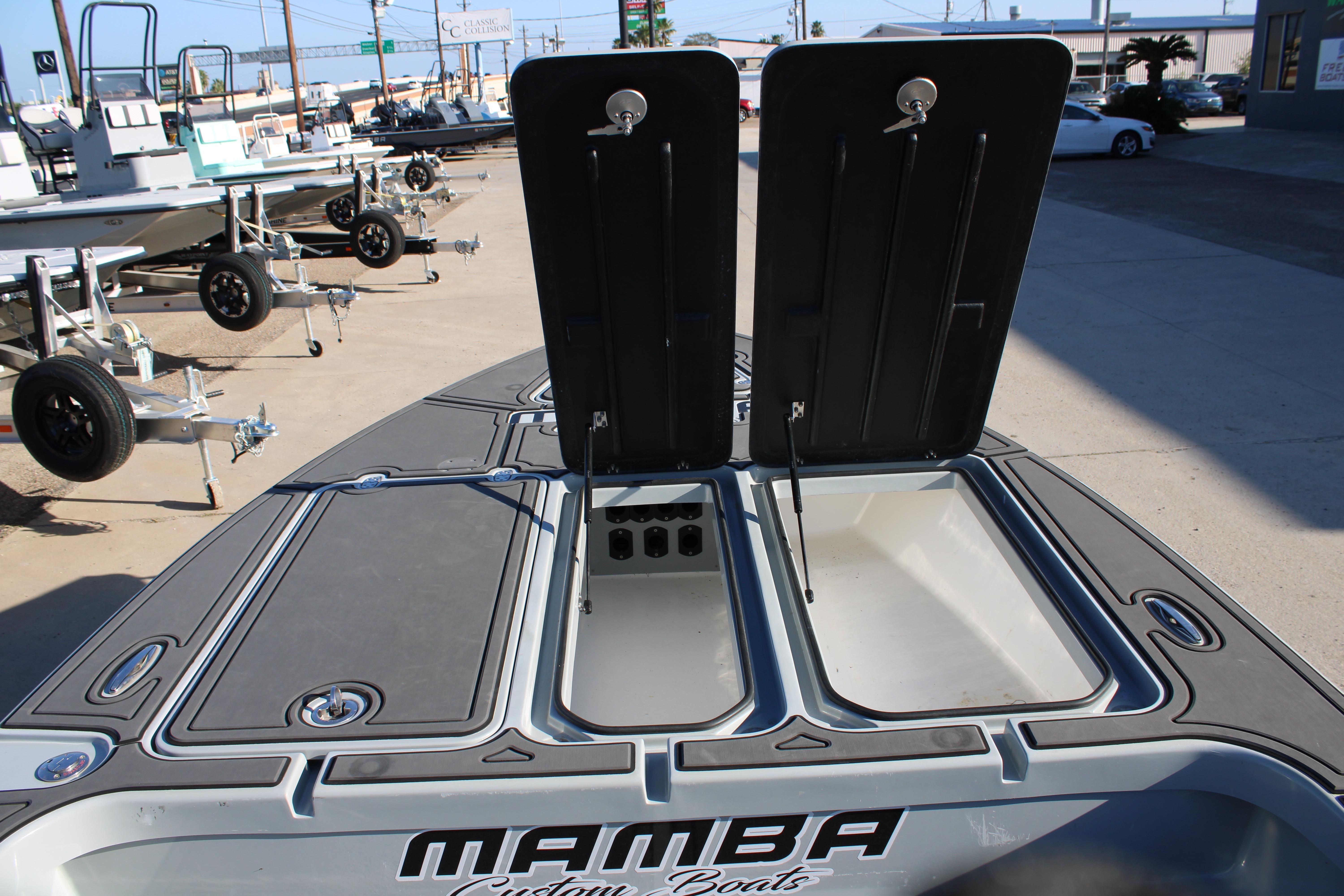 Open storage compartments on a 2025 Mamba 227VX boat, showcasing spacious design.