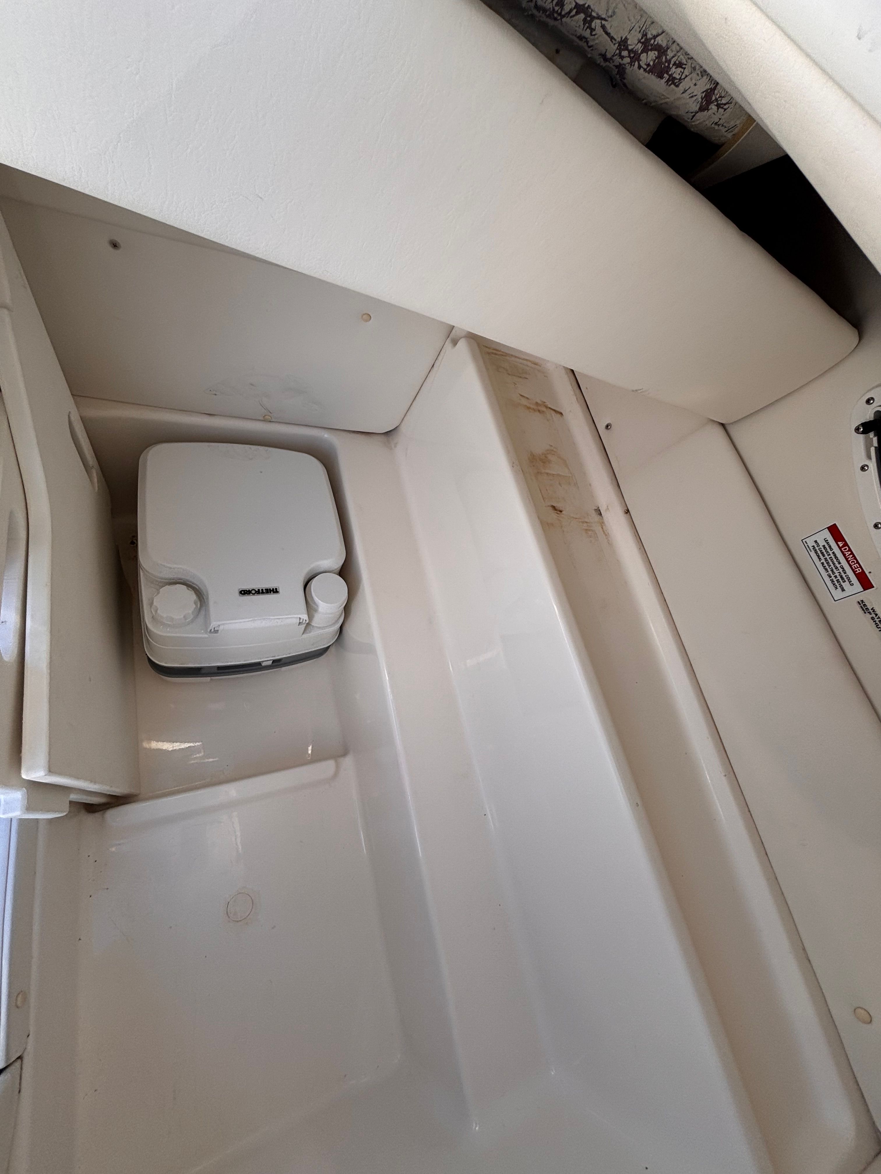 Interior of 2024 Bayliner VR6 Bowrider OB with storage space.