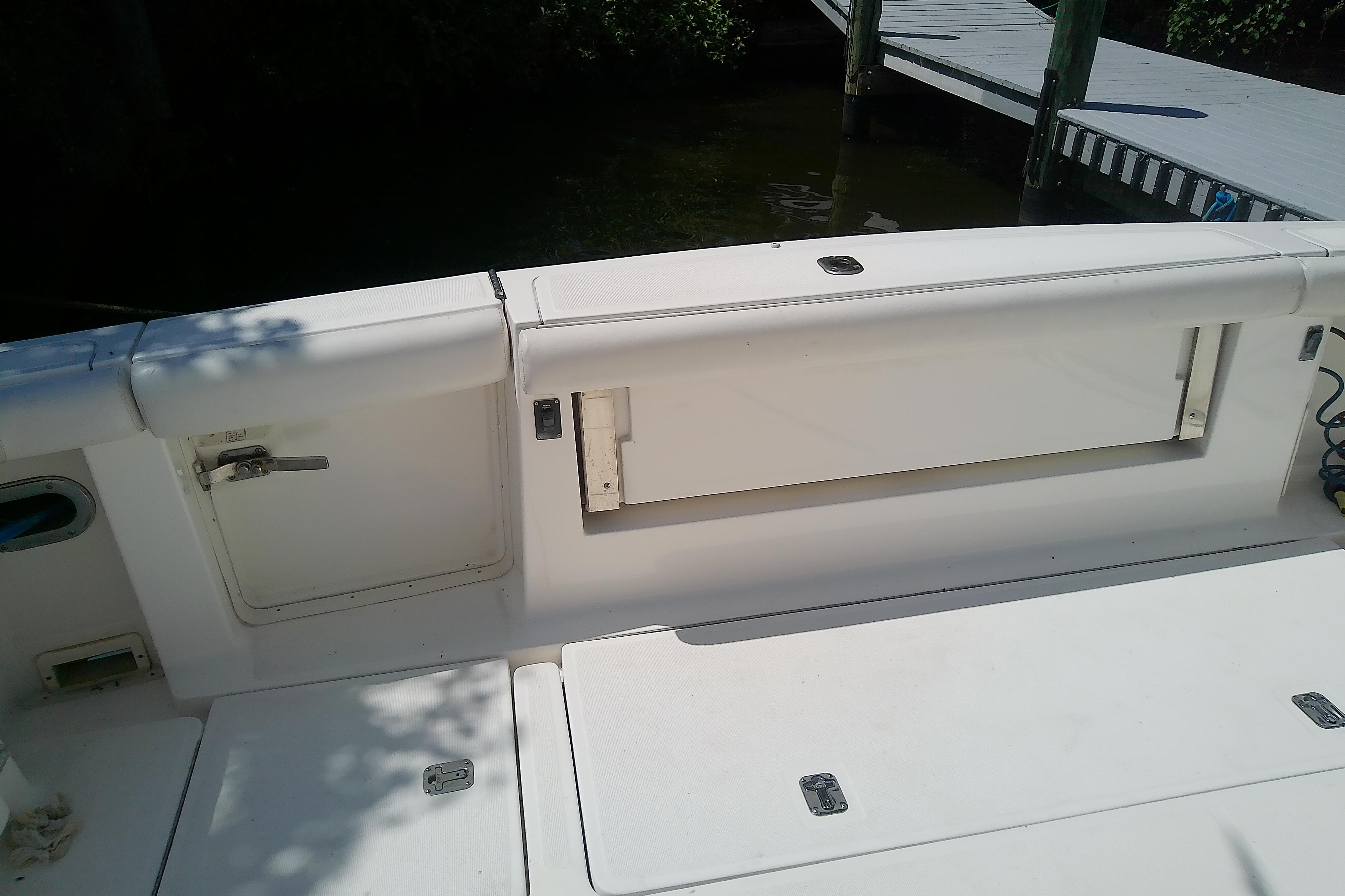 2000 Tiara Yachts 4100 Open boat deck with storage compartments and dock view.