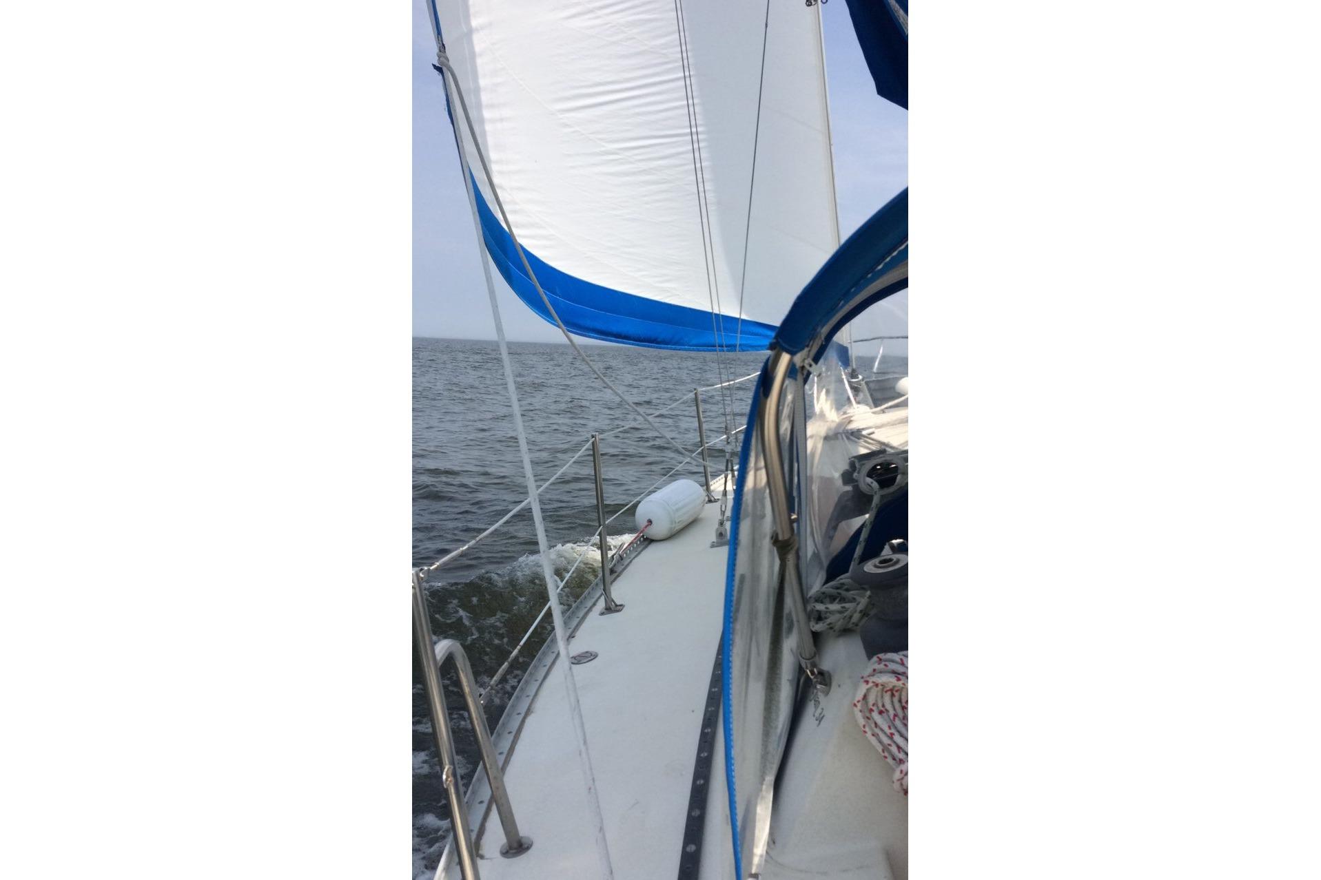 1982 San Juan 34 sailboat cruising on open water.