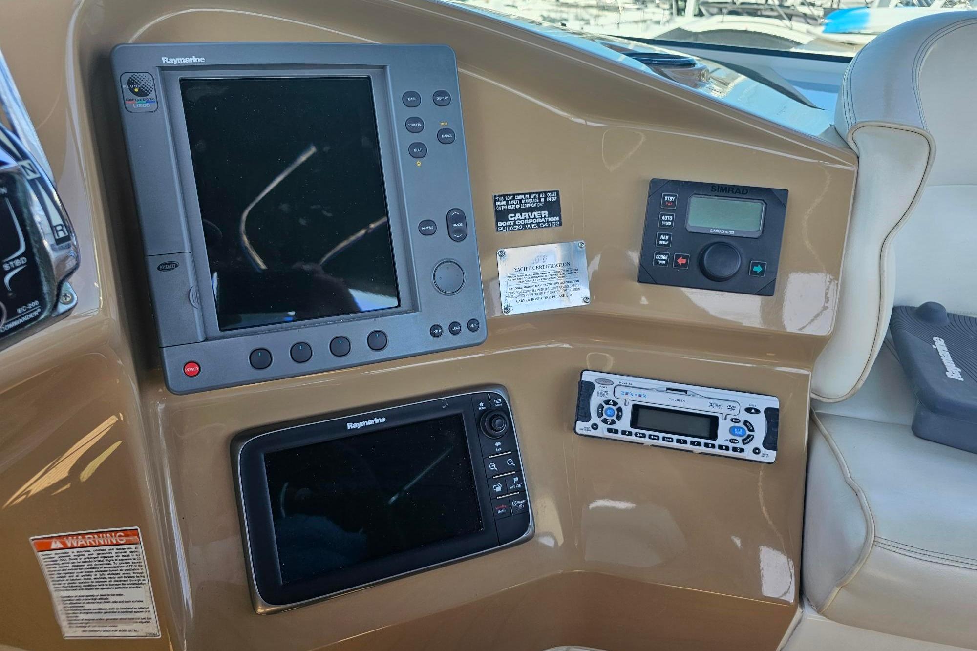 Control panel of a 2002 Carver 450 Voyager Pilothouse with navigation and communication equipment.