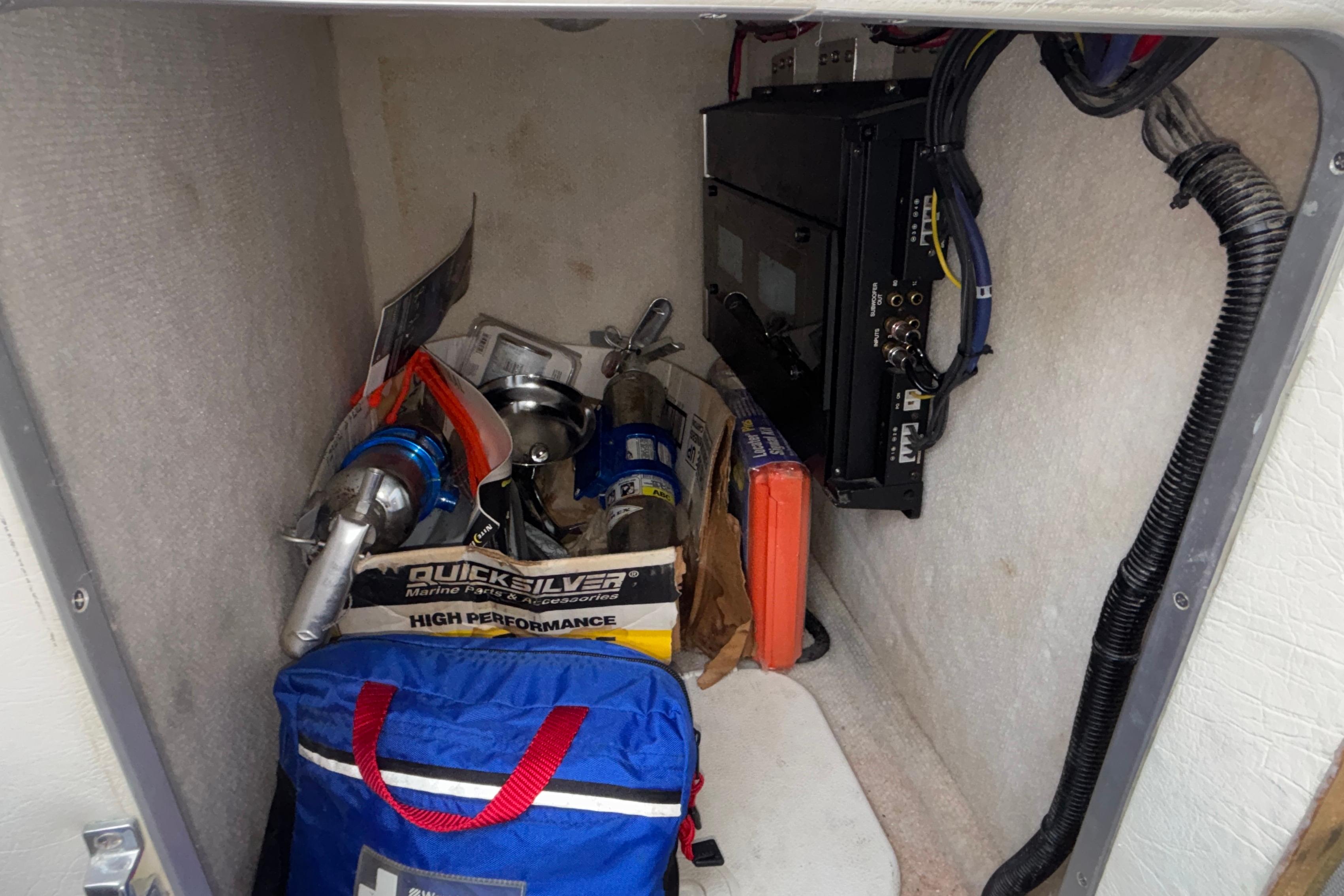 Storage compartment of a 2003 Cigarette 38' Top Gun boat with marine accessories.