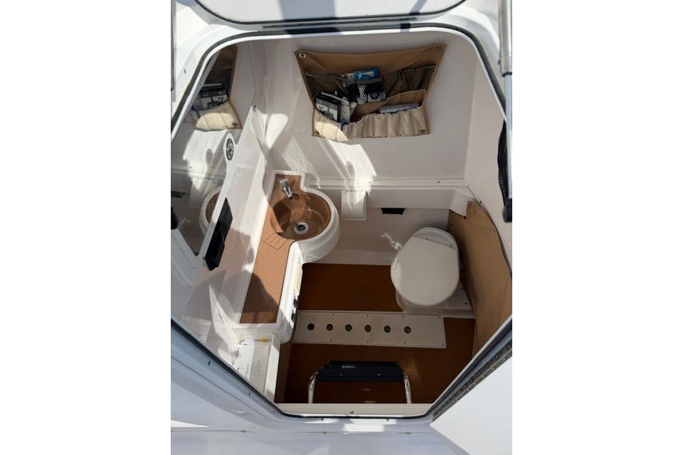 Interior of 2014 Southport 29 FE boat featuring compact bathroom amenities.