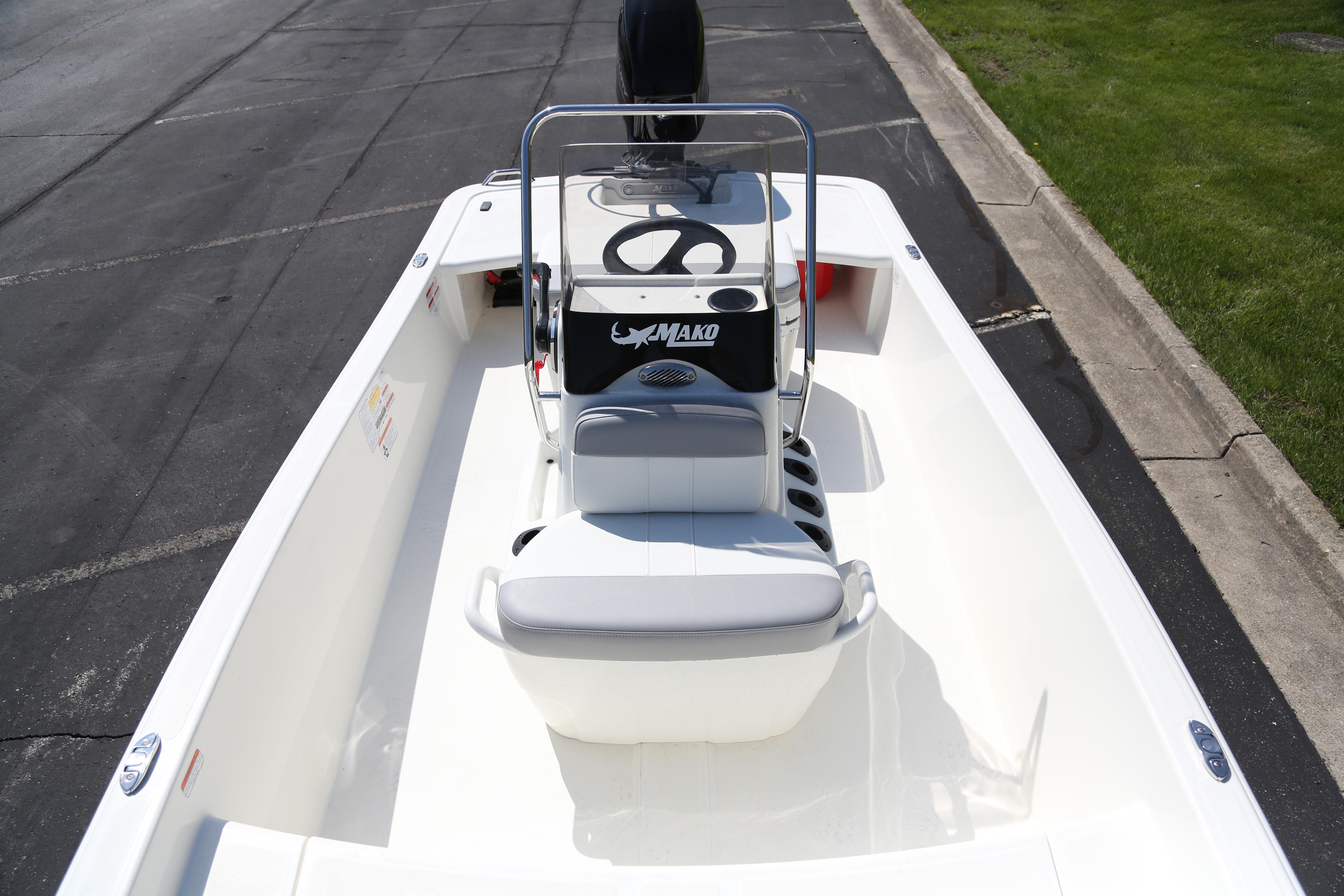 2026 Mako Pro Skiff 15 CC boat with center console on a paved surface.