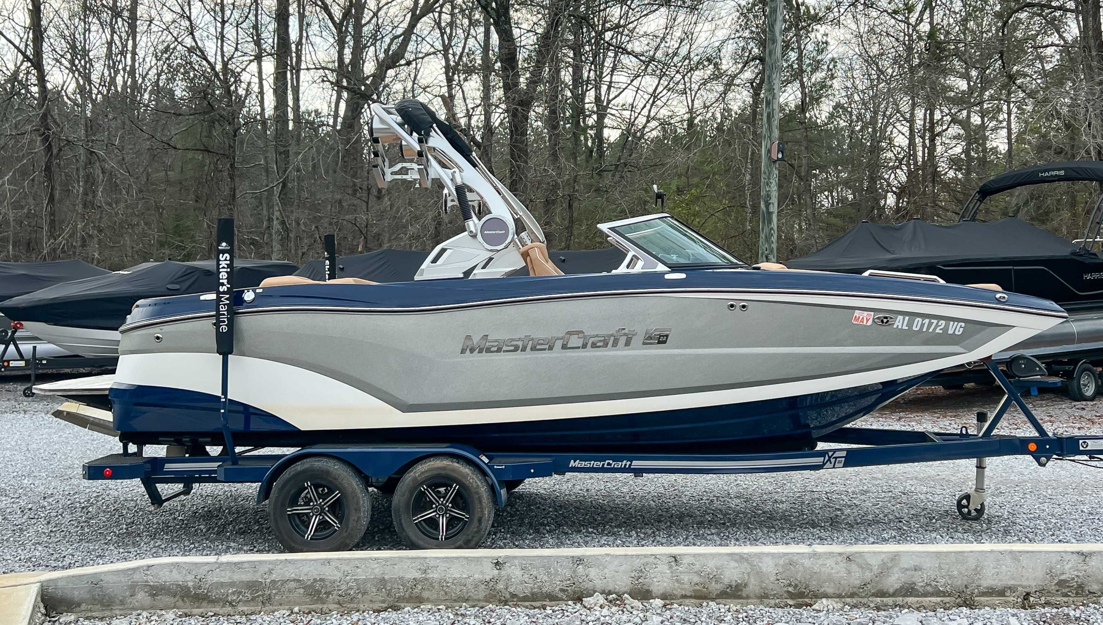 2021 MasterCraft XT22 boat parked on trailer outdoors.
