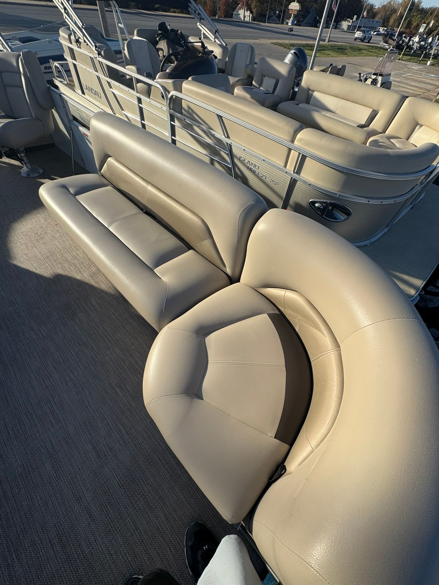 2024 Landau Island Breeze 252 pontoon boat with beige leather seating.