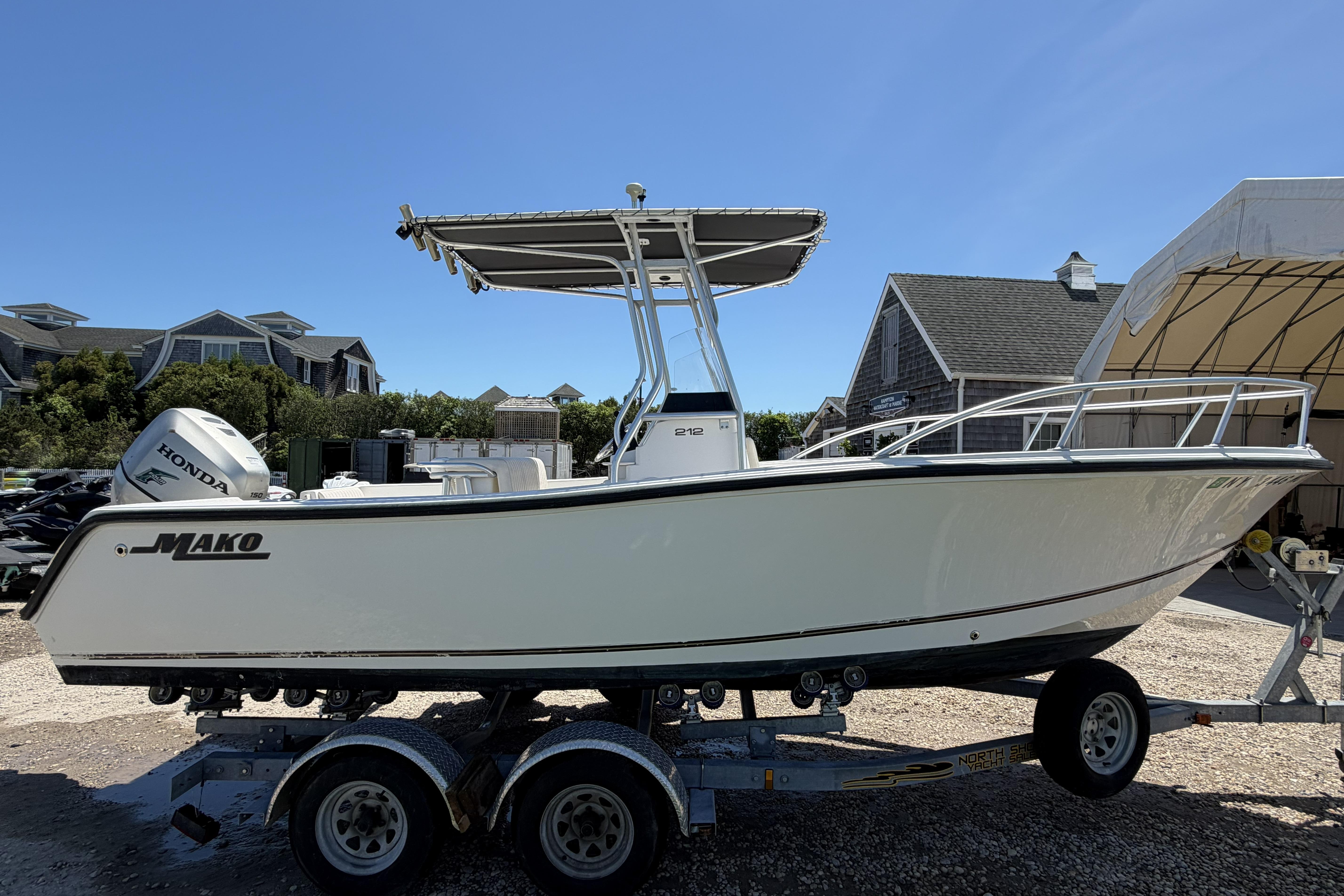2006 Mako 212 Center Console boat on trailer, featuring Honda outboard motor.
