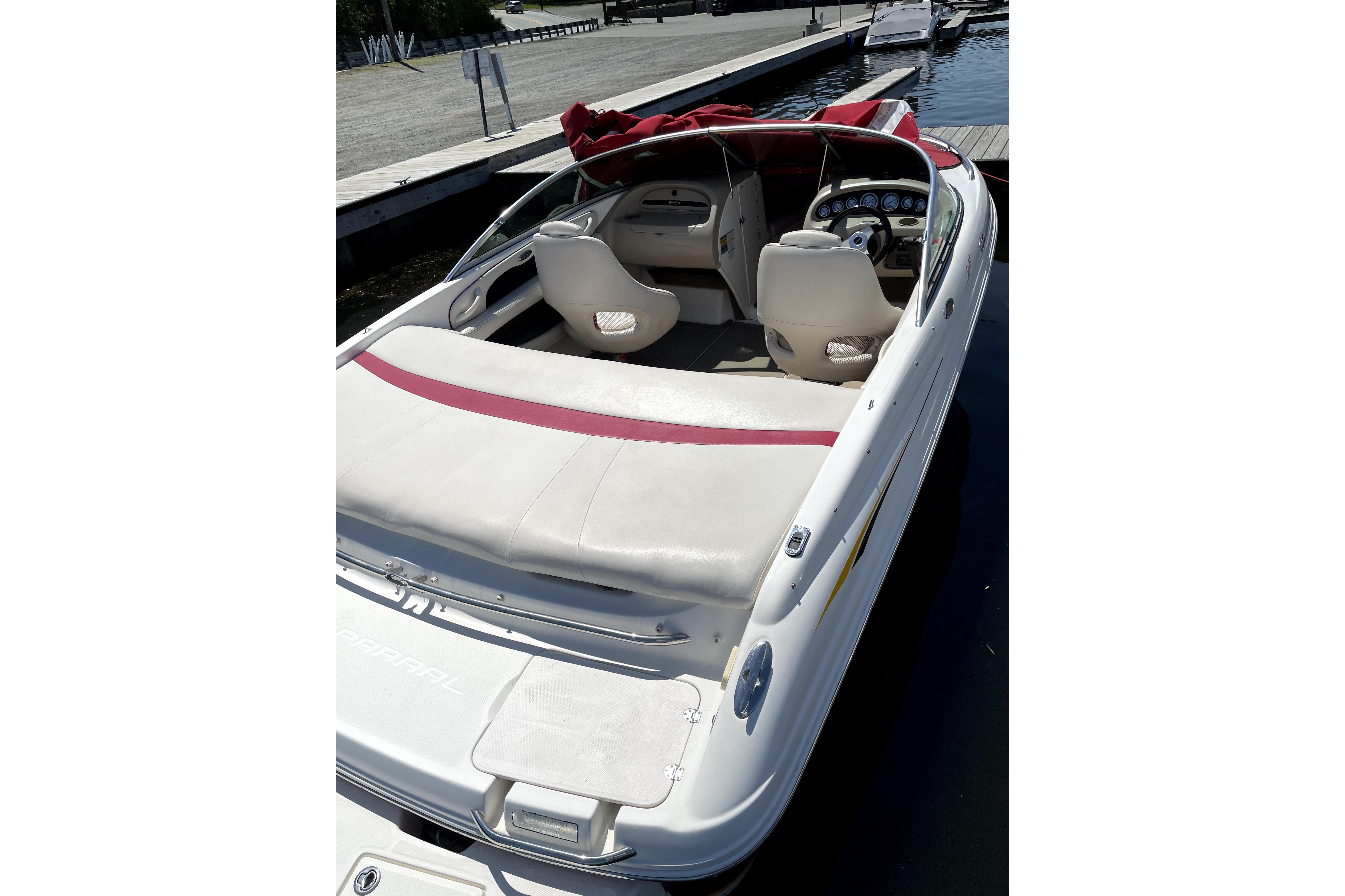 2003 Chaparral 200 SSi boat docked, featuring white and red interior seating.
