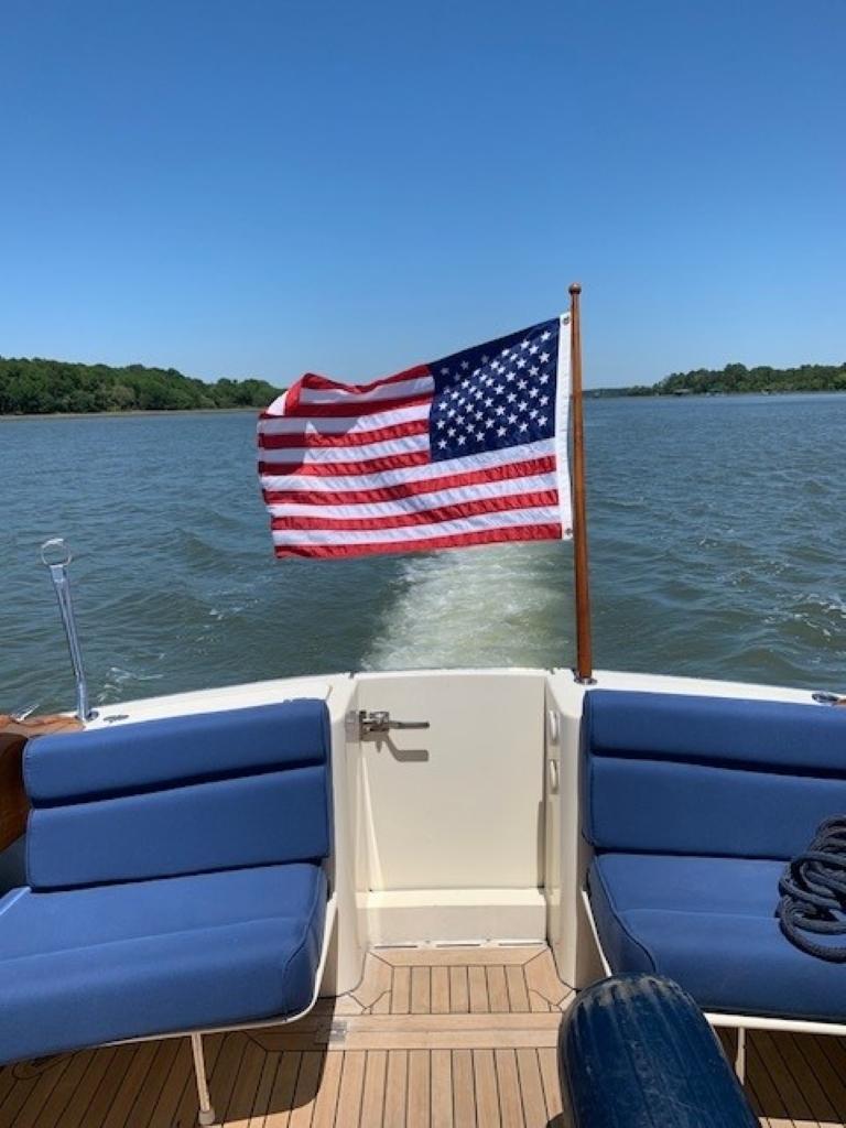 Hinckley Talaria 44 FB 2002 boat with American flag on open water.