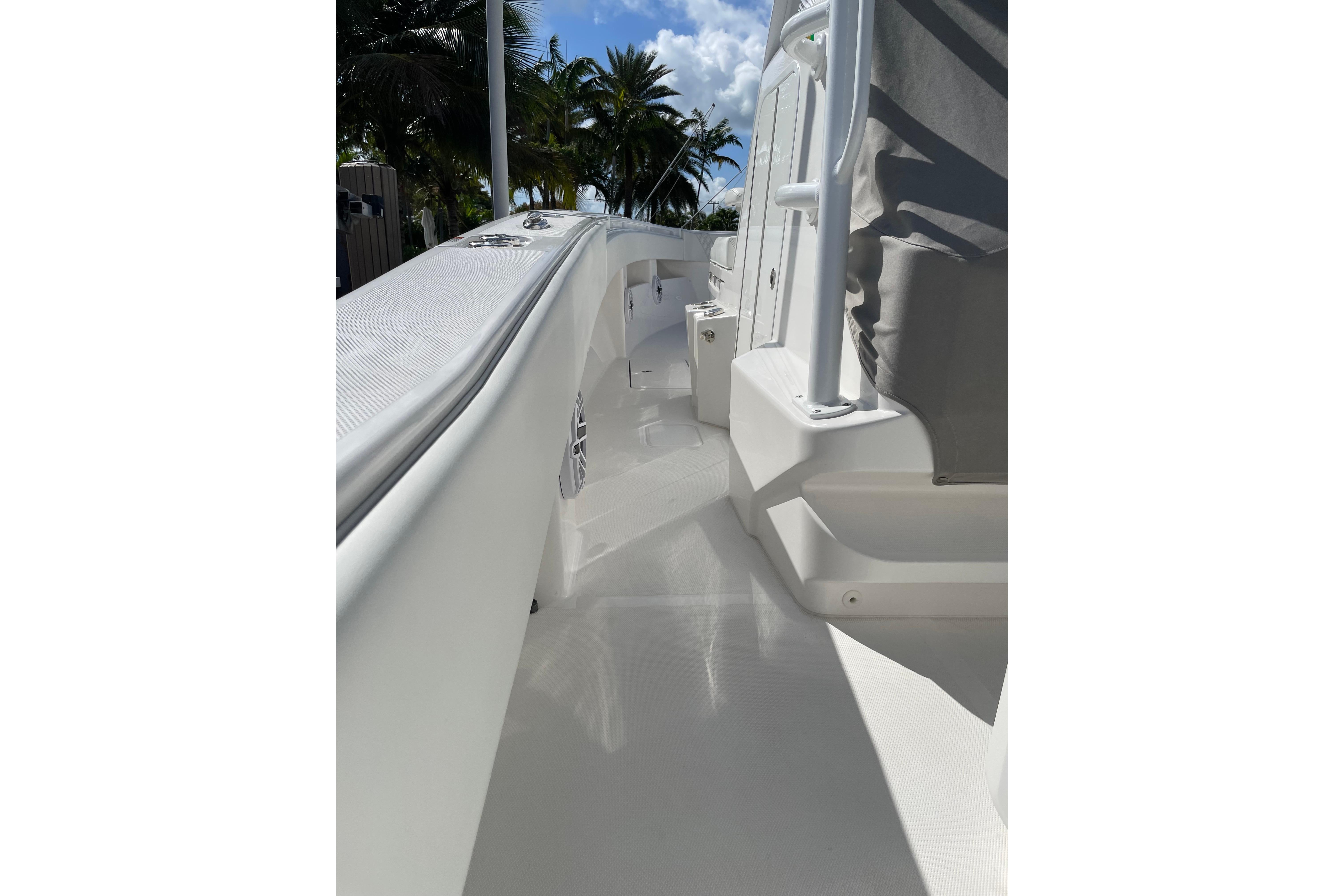 2024 Invincible 36 Open Fisherman boat deck with sleek white design and palm trees.