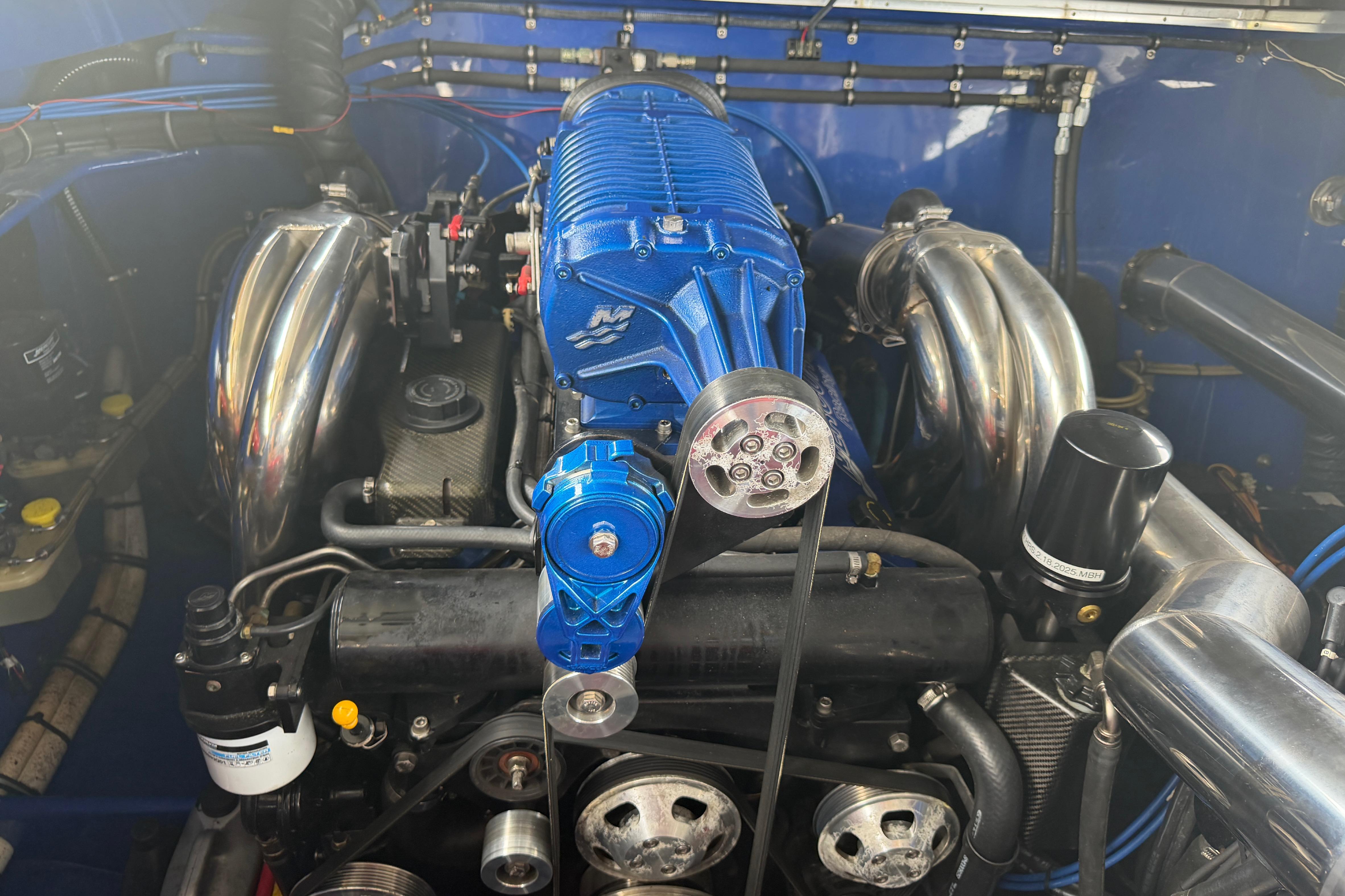 Engine of 2013 Nor-Tech 477 SPX Vee Bottom with blue supercharger and chrome components.