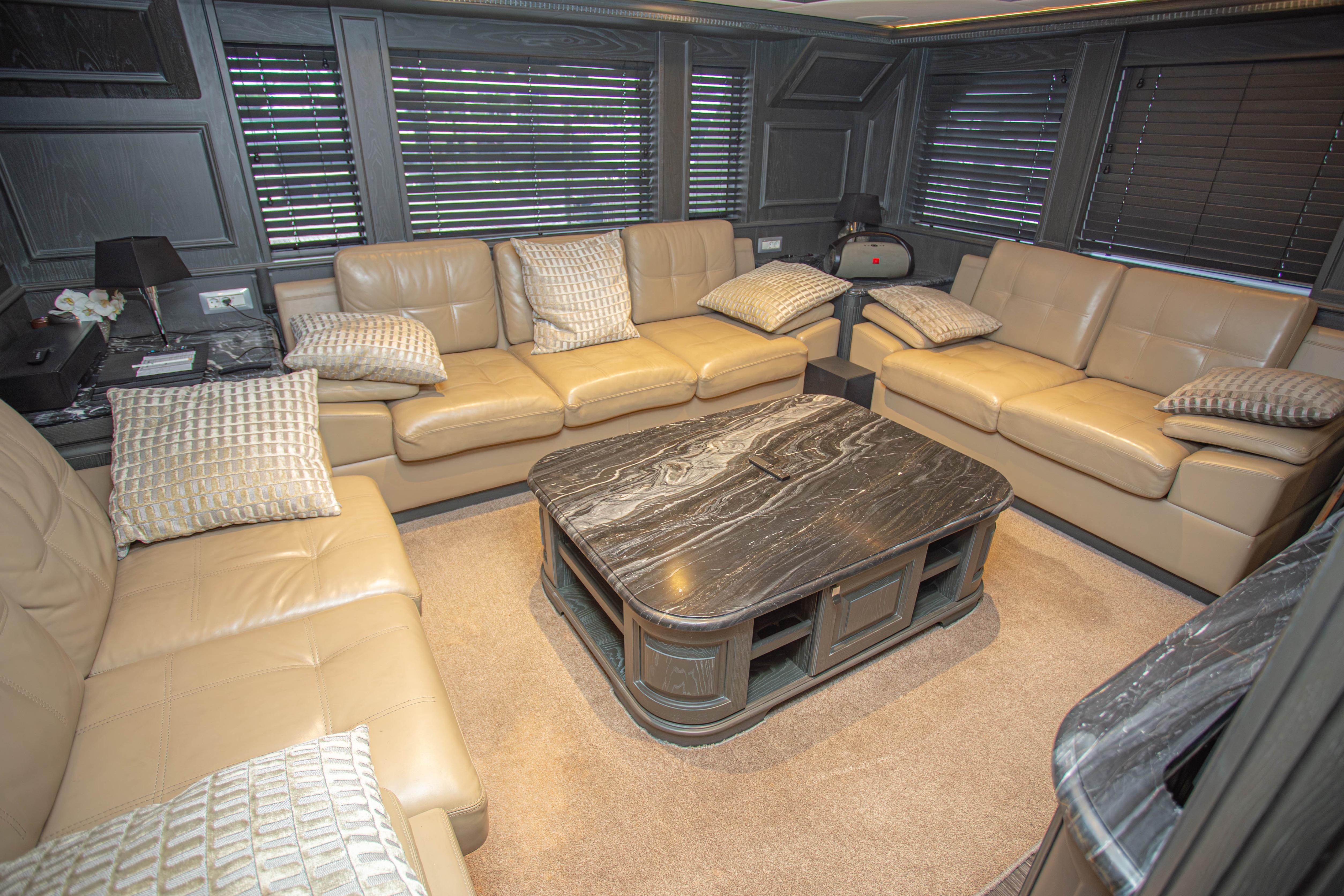 Luxurious interior of 2014 Fifth Ocean Yachts 24m Explorer, featuring leather sofas and elegant decor.