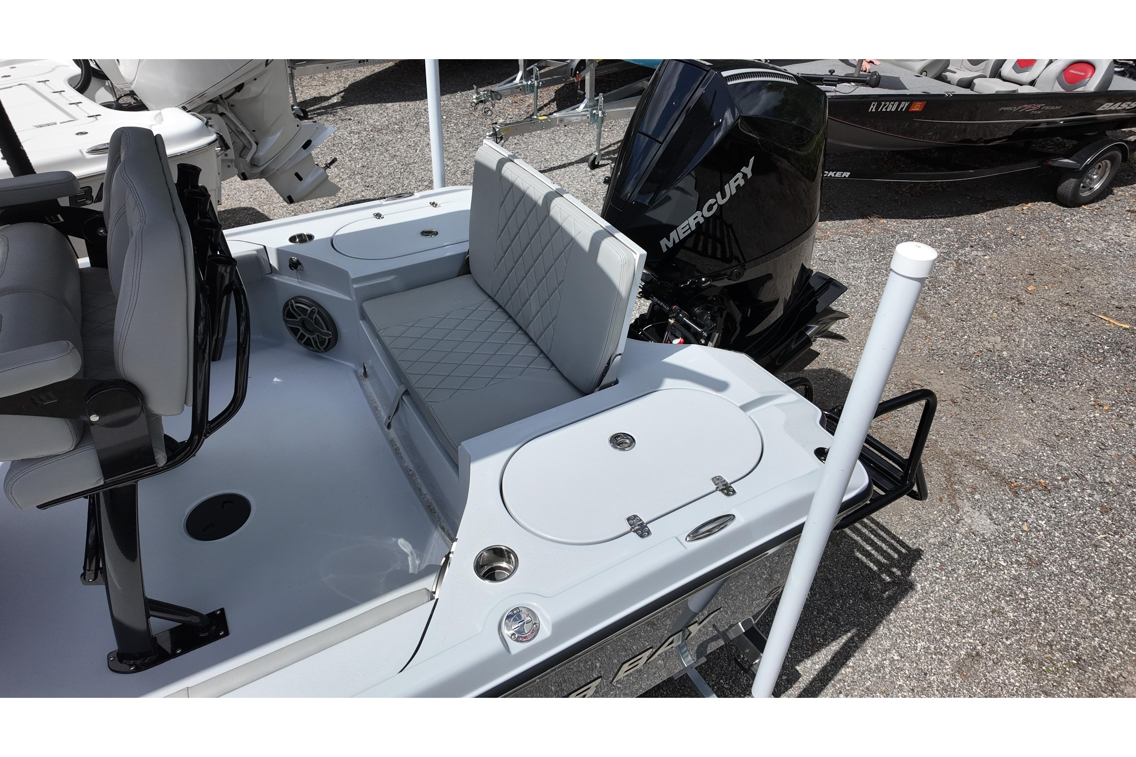 2026 Blazer Bay 2440 boat with Mercury engine, featuring seating and storage compartments.