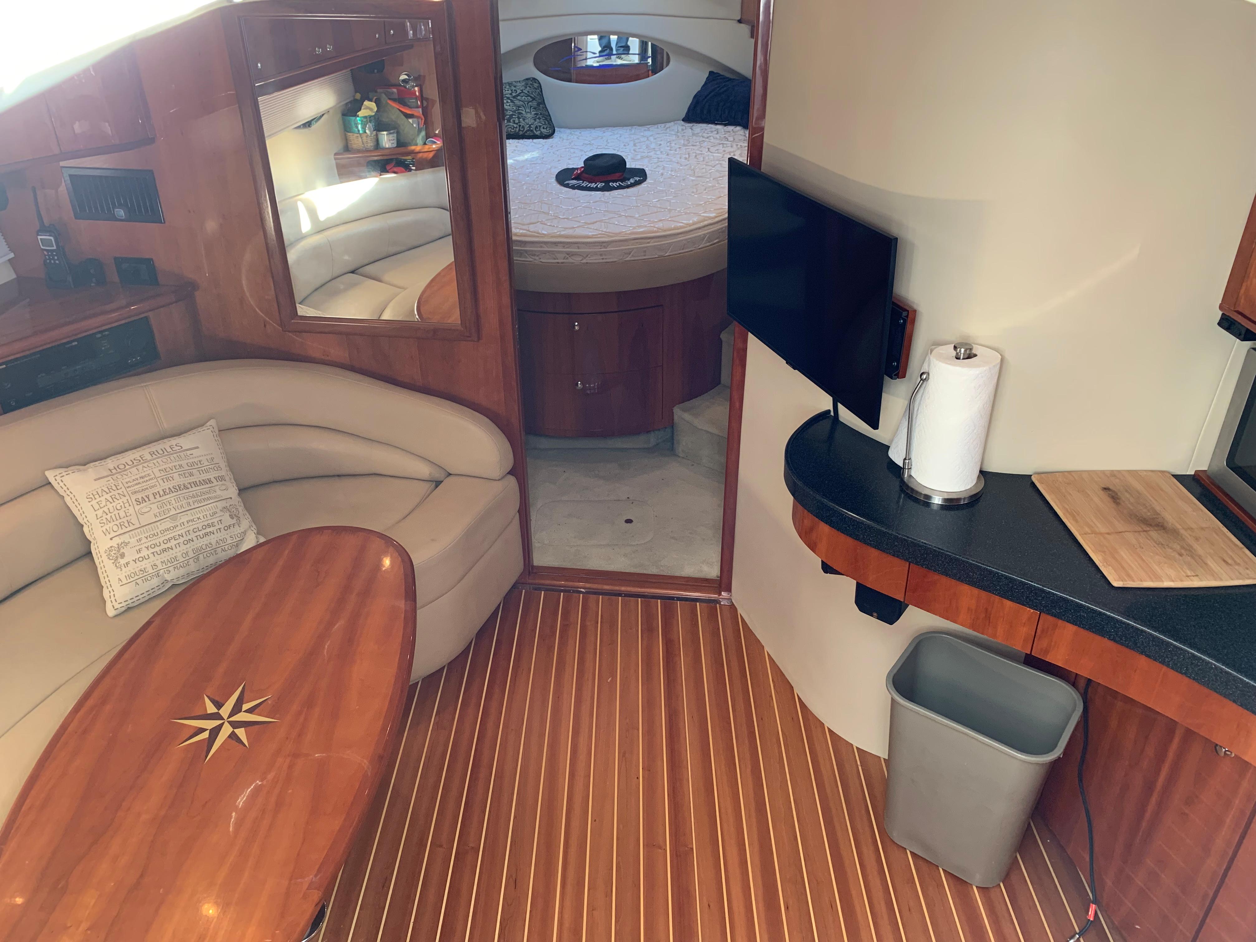 Interior of a 2009 Regal 4460 yacht with wood flooring and cozy seating area.