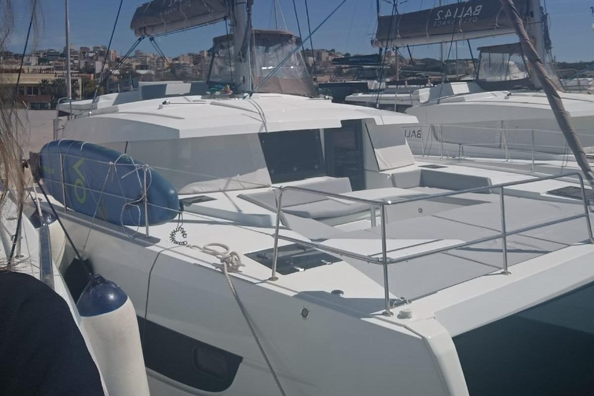 2023 Bali 4.2 catamaran docked at marina, featuring spacious deck and modern design.