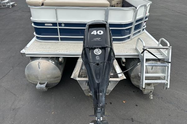 A 2018 South Bay S224CR pontoon boat with a 40 HP outboard motor, parked on a lot.