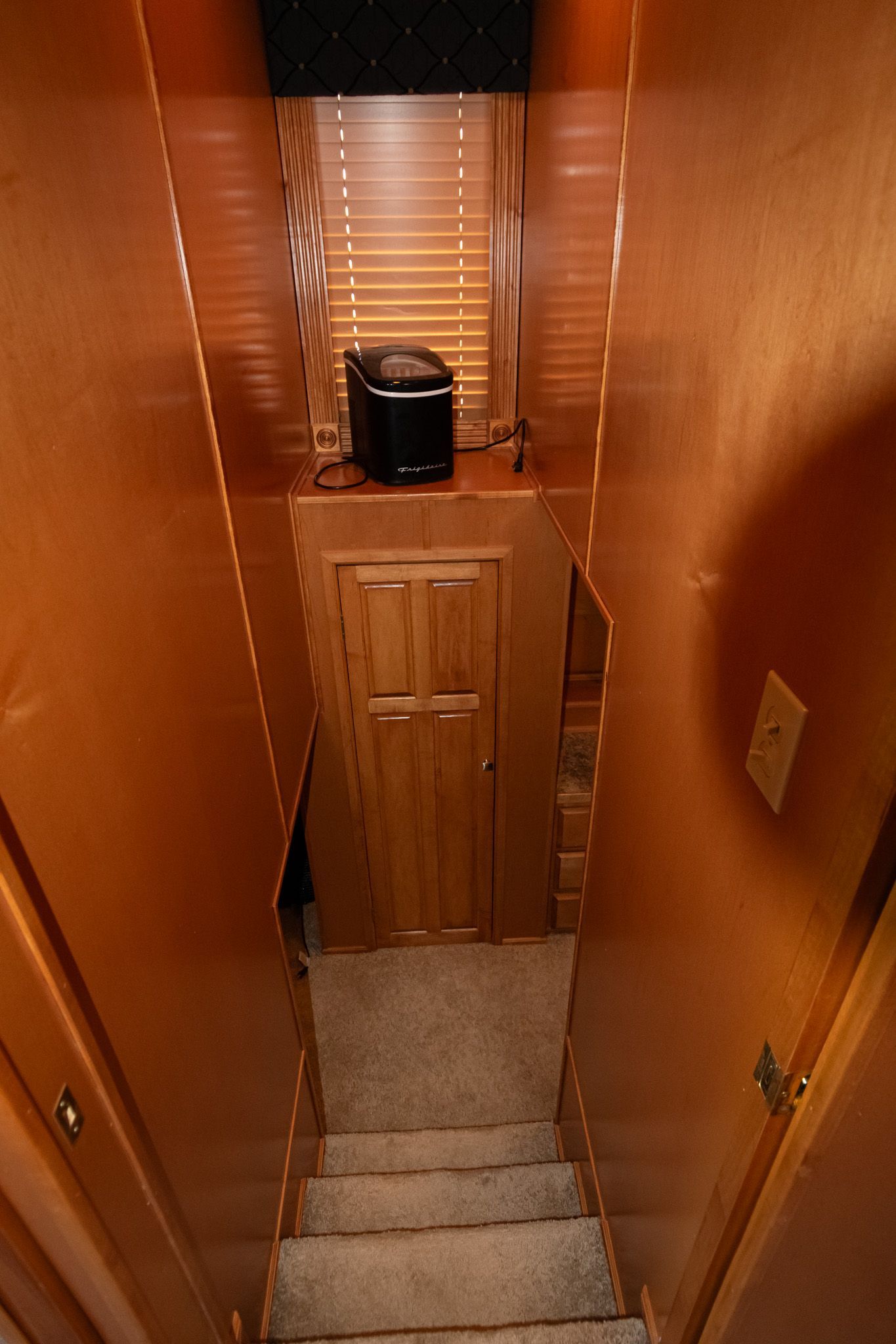 Interior of a 2003 Lakeview 16x70 houseboat with stairs and wood paneling.