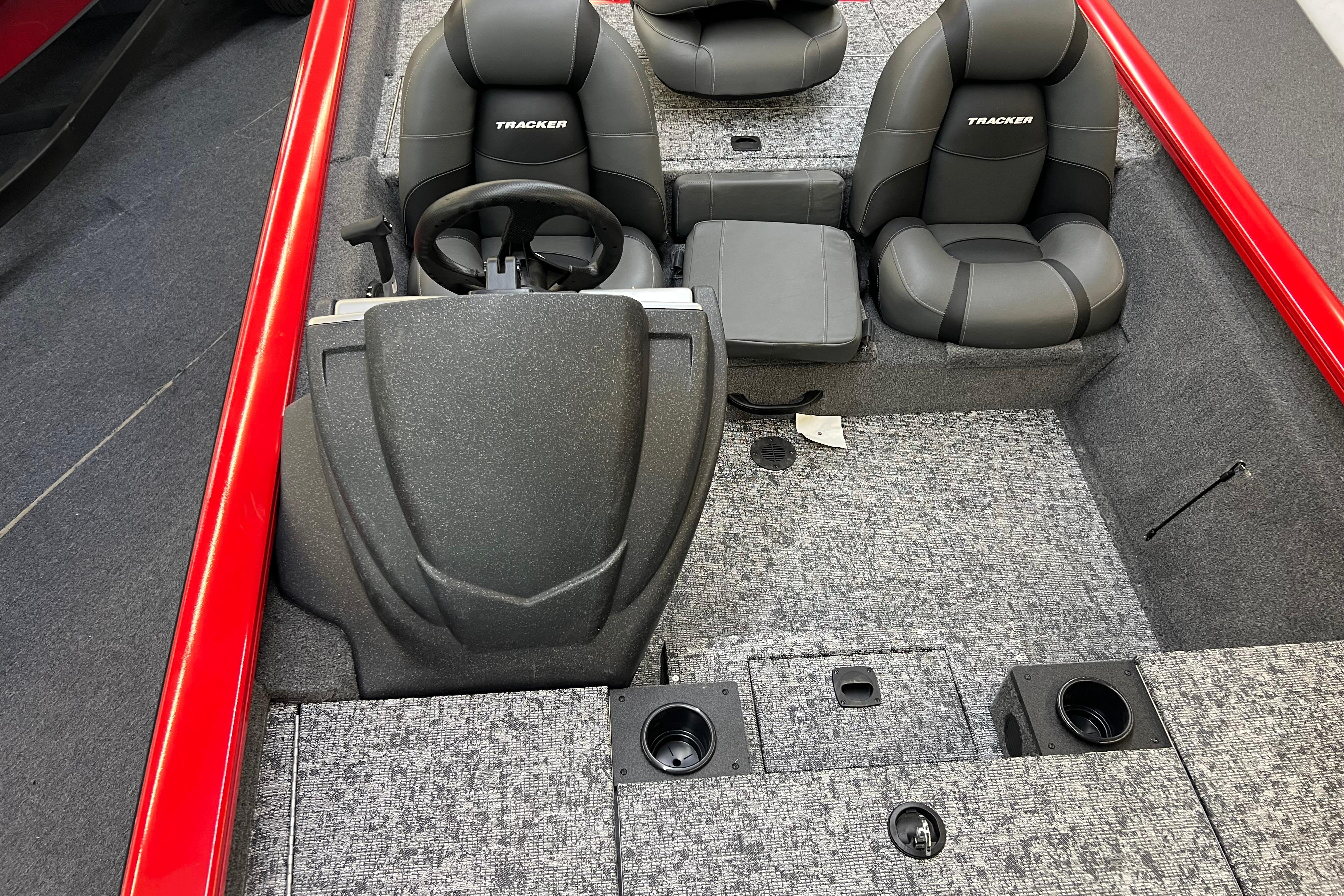 2026 Tracker Pro Team 190 boat interior with gray seats and red accents.