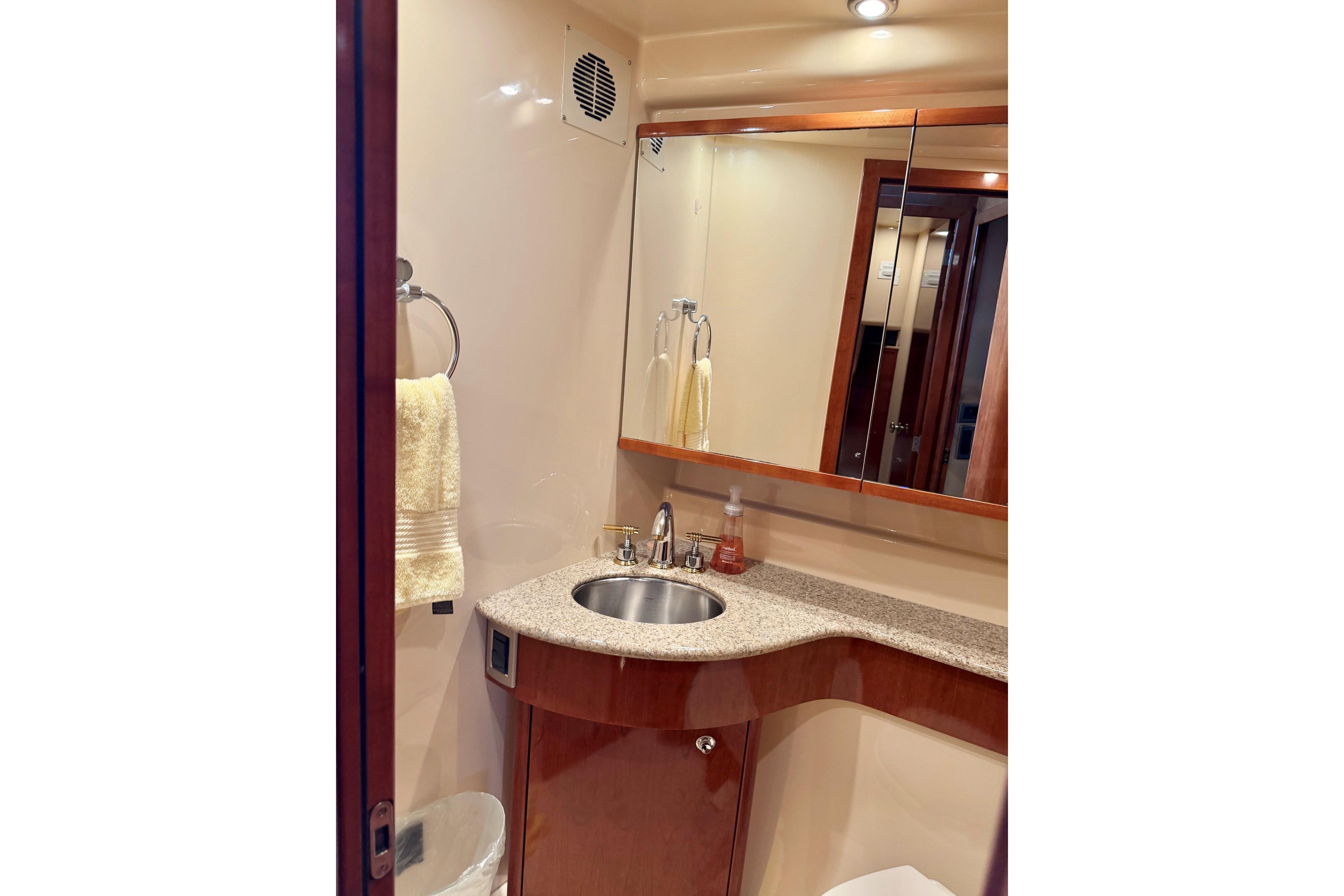 Luxurious bathroom in 2007 Meridian 391 Sedan yacht with modern fixtures and elegant design.