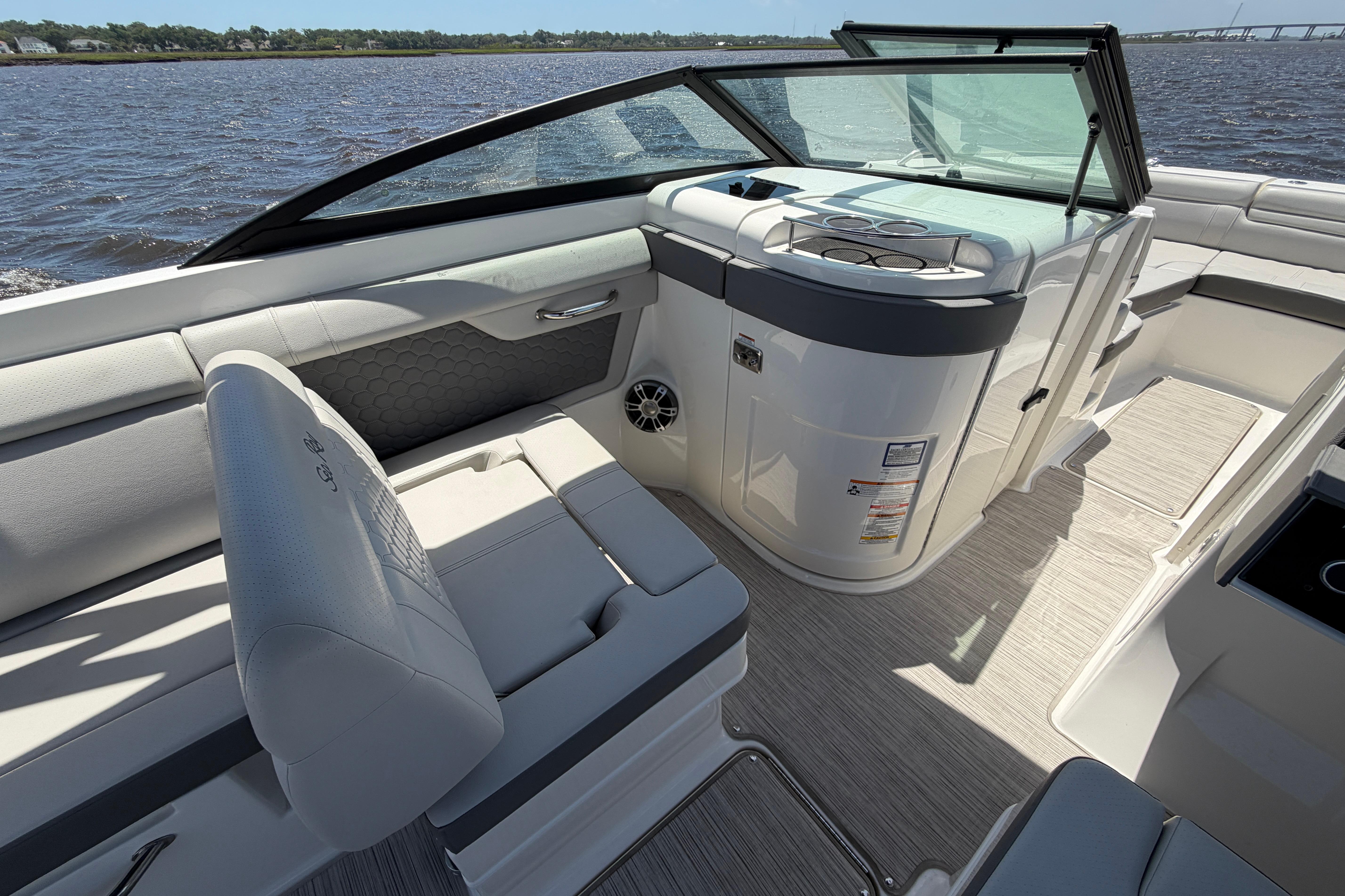 2024 Sea Ray SDX 270 Outboard boat interior with seating and helm, on a sunny day.