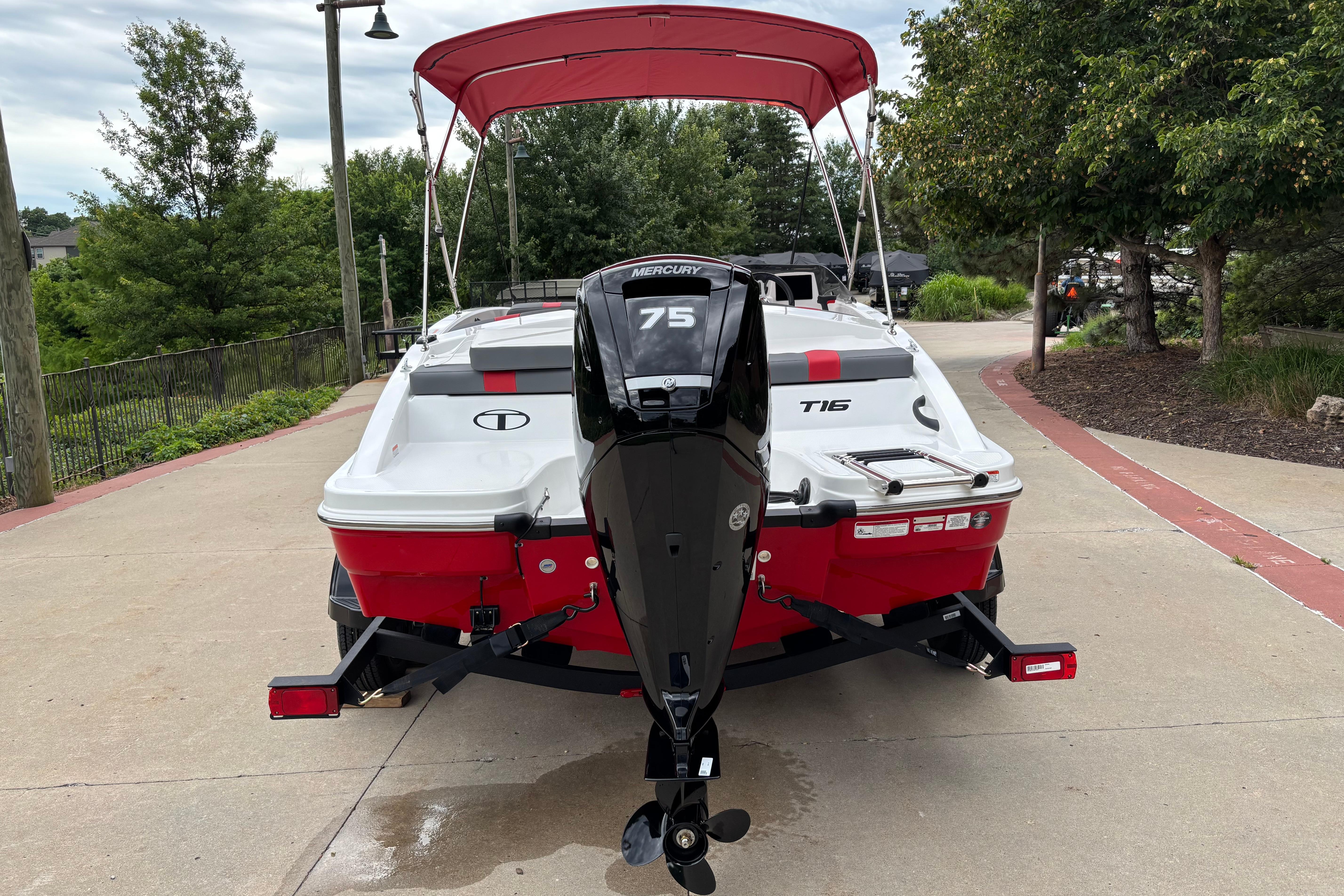 2026 Tahoe T16 boat with Mercury 75 engine, parked on a driveway.