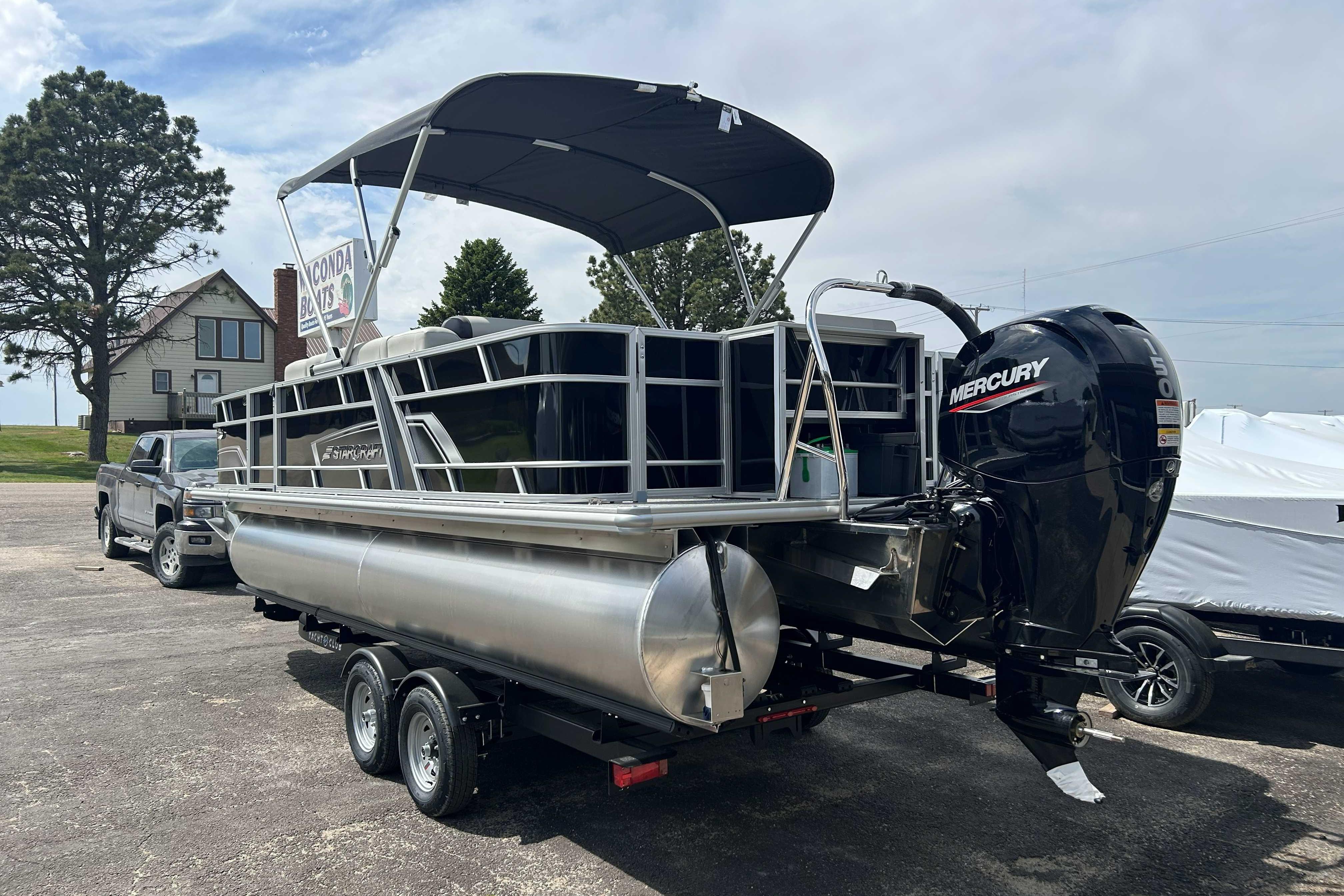 2026 Starcraft EX 22 FD pontoon boat with Mercury outboard motor on trailer.