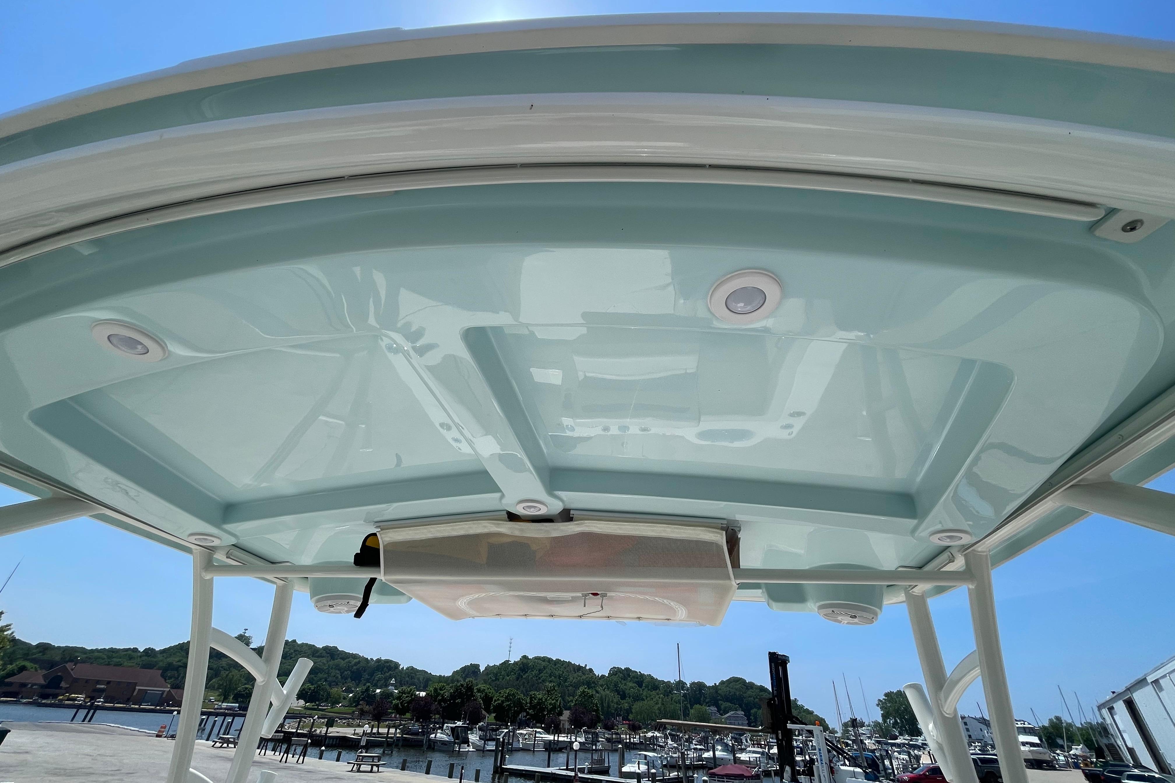 2022 Sailfish 245 DC boat canopy with integrated lights, docked at marina.