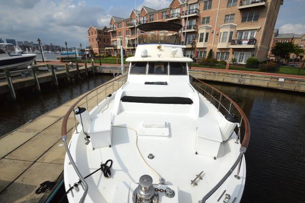 A 1980 Hatteras 53 Yacht Fisherman docked in a marina.