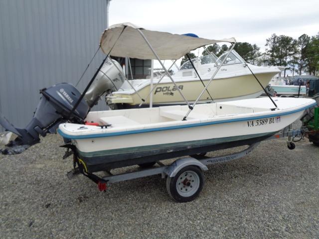 2010 Sundance K14T boat with canopy on trailer, parked on gravel.