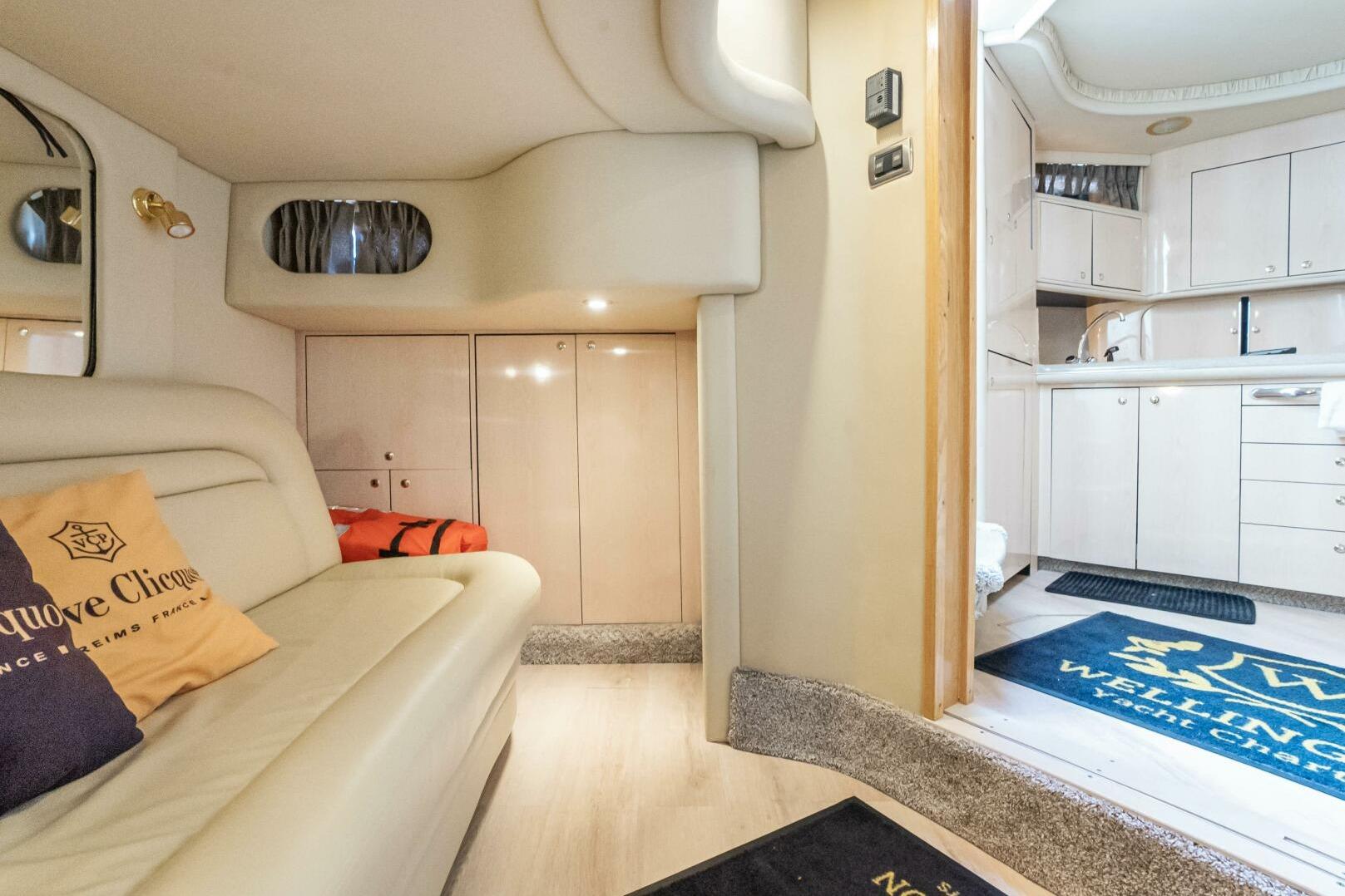 Luxurious interior of 2003 Sea Ray Sundancer 460 yacht with modern kitchen and cozy seating area.