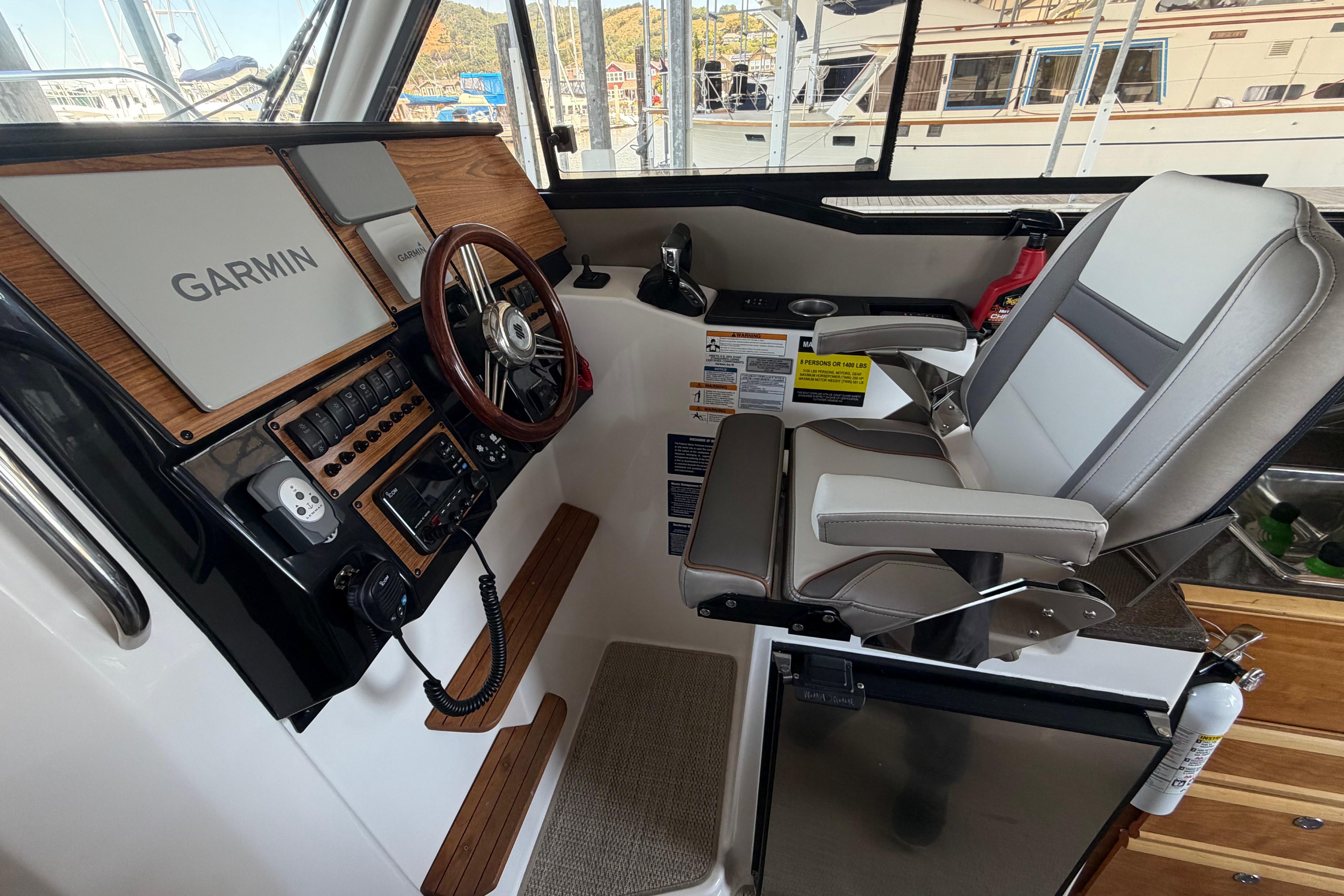 2023 Cutwater C-288 Coupe helm with Garmin navigation, luxurious seating, and modern controls.