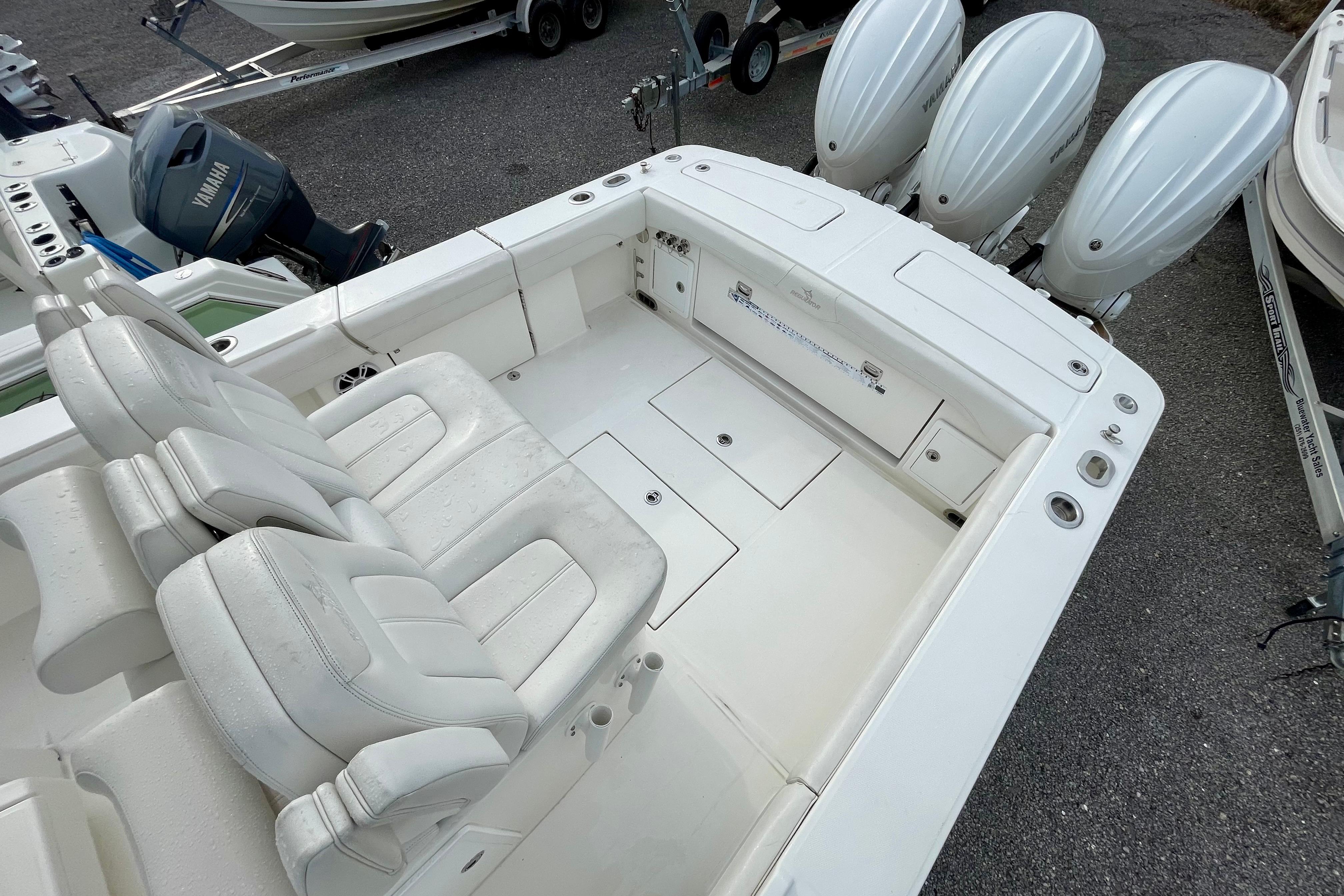 2023 Regulator 34 boat with triple outboard engines and spacious seating area.