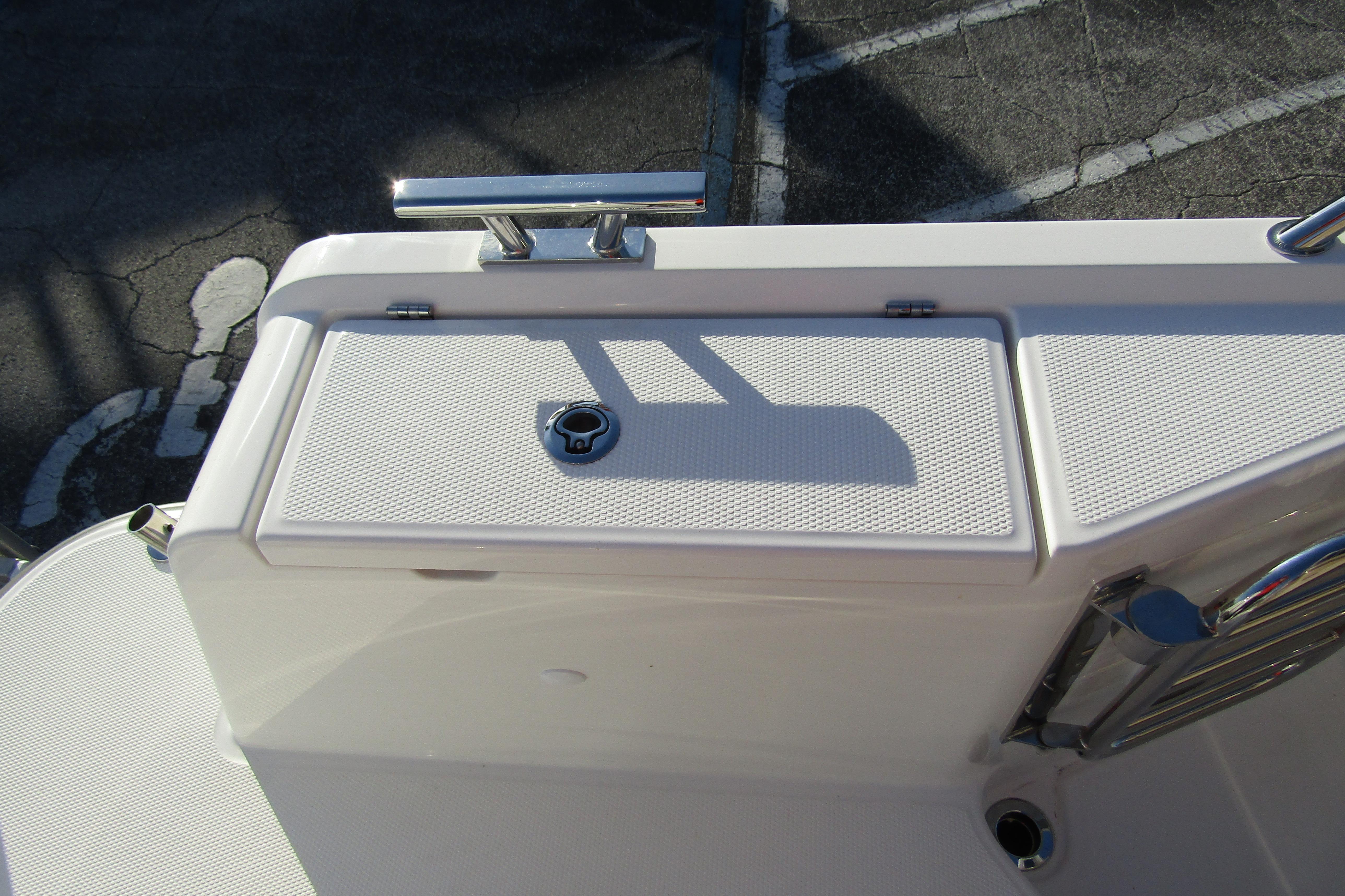 2025 Nimbus Tender 9 boat deck with storage compartment and railing.