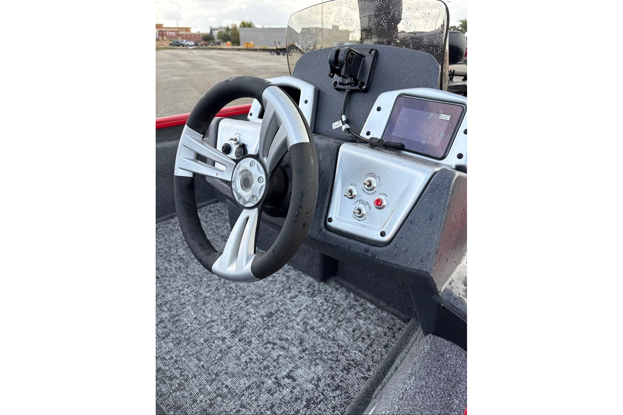 2026 Tracker Pro Team 175 boat dashboard with steering wheel and control panel.